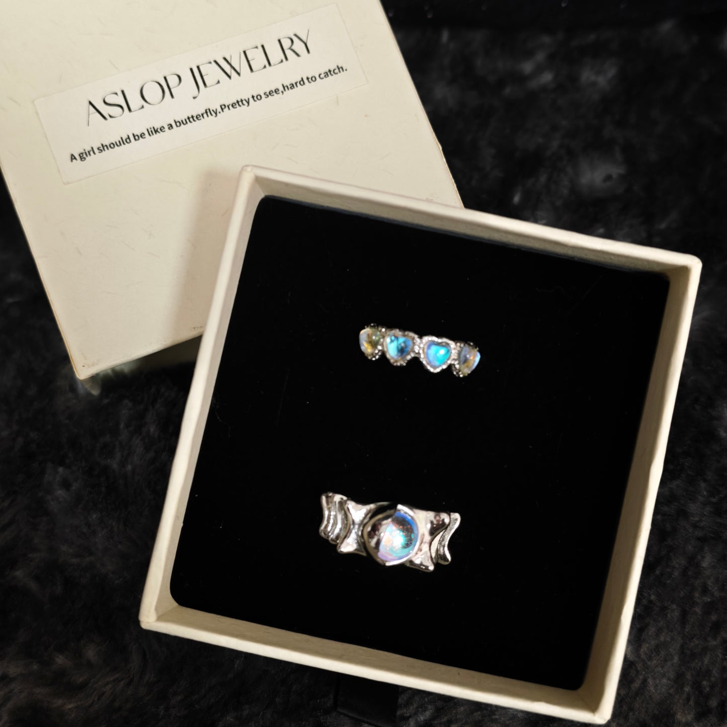 Moonlit hearts ring set in open Aslop Jewelry white gift box, overhead flat view