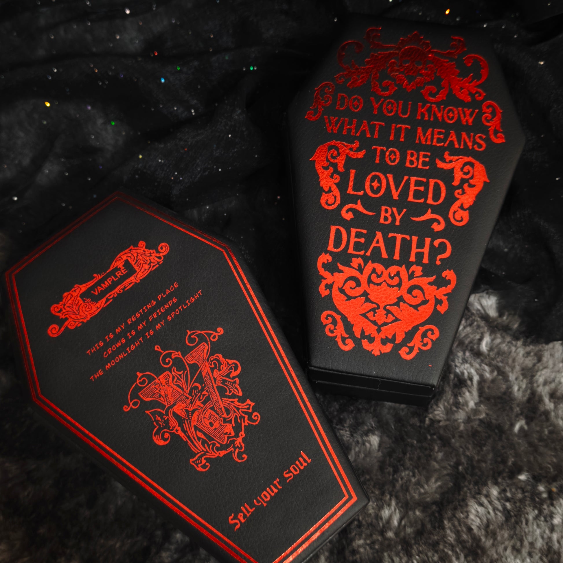 Black coffin jewelry box back panel with red foil Vamplre crest and gothic text, close-up flat view