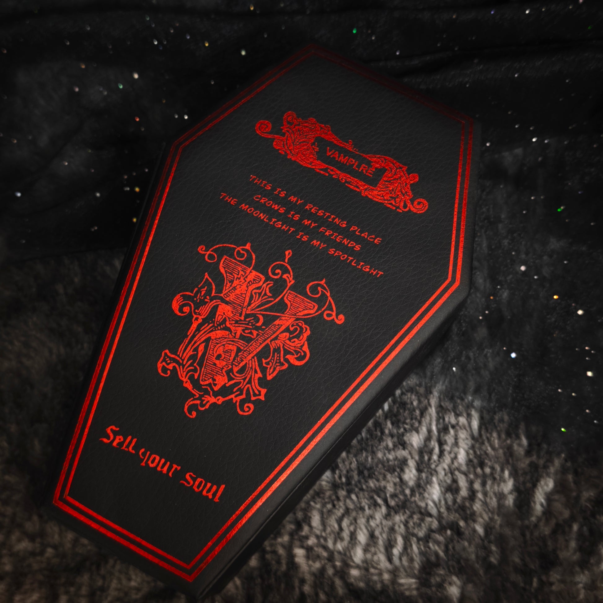 Black coffin jewelry box back panel with red foil Vamplre crest and gothic text, close-up flat view