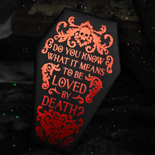 Black coffin jewelry box back panel with red foil crest and text on black glitter background