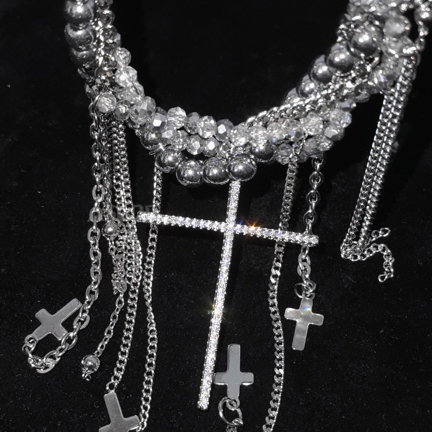 Multi-layered silver chain necklace with crystal beads, cascading fringe tassels and large rhinestone cross pendant