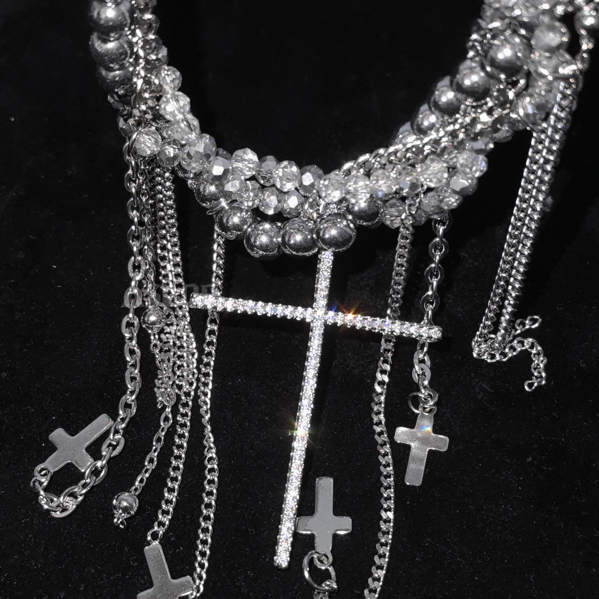 Multi-layered silver chain necklace with crystal beads, cascading fringe tassels and large rhinestone cross pendant