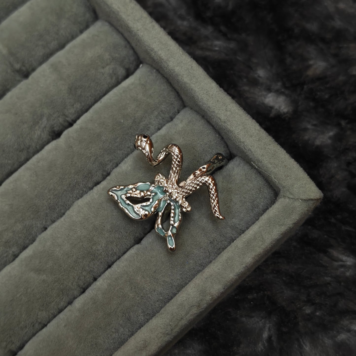 Standalone ring on grey velvet display, close-up angle