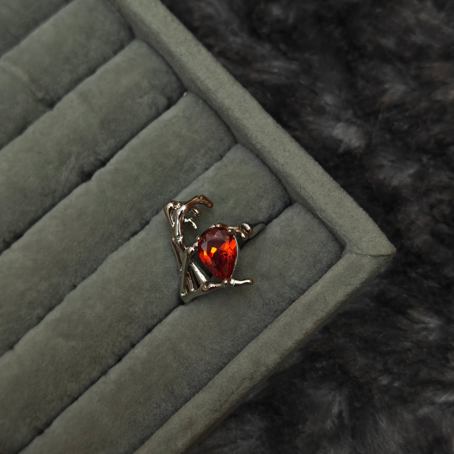 Individual gothic charm ring shown alone on grey velvet tray, front detail view