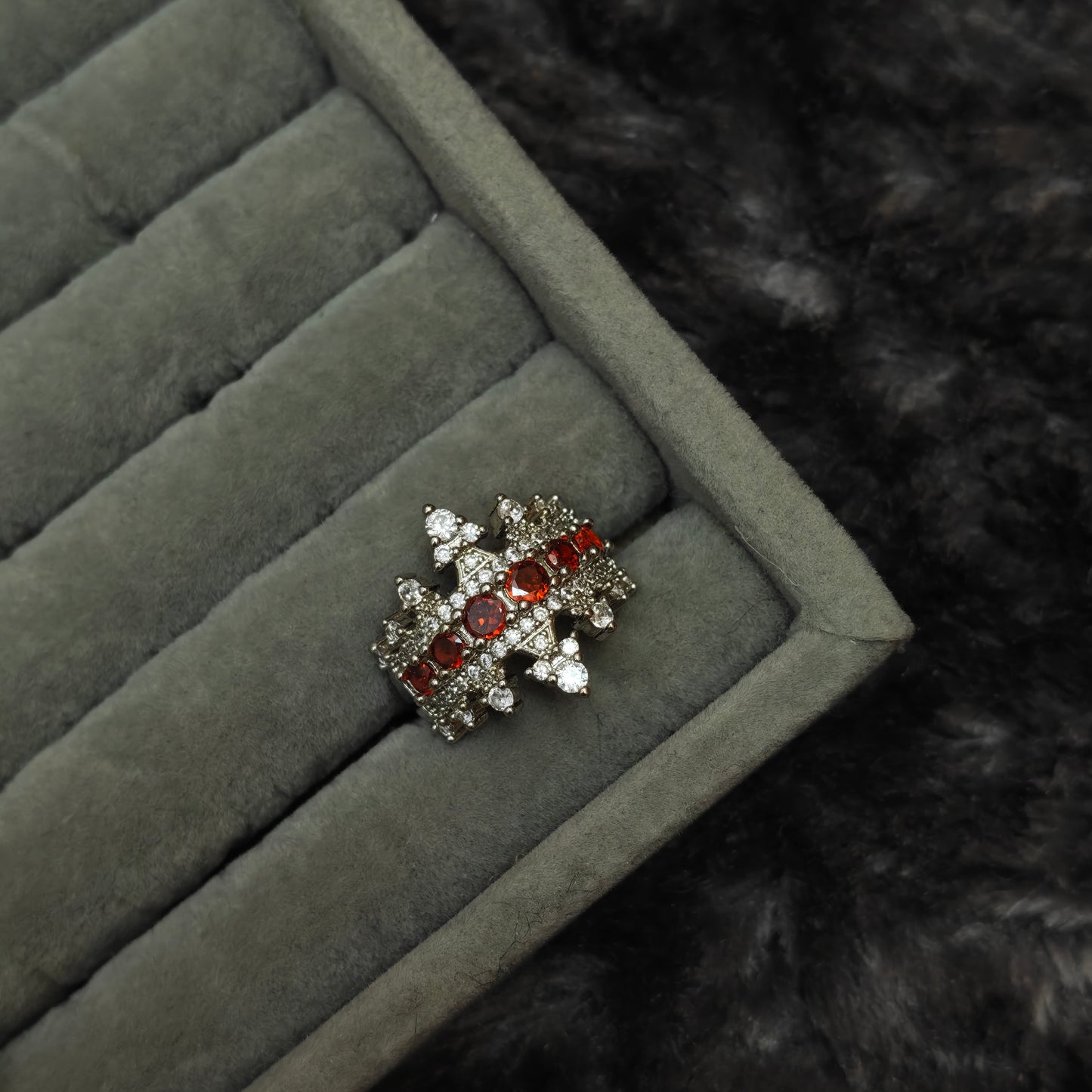 Single gothic statement ring displayed individually on grey velvet tray, close-up product photo