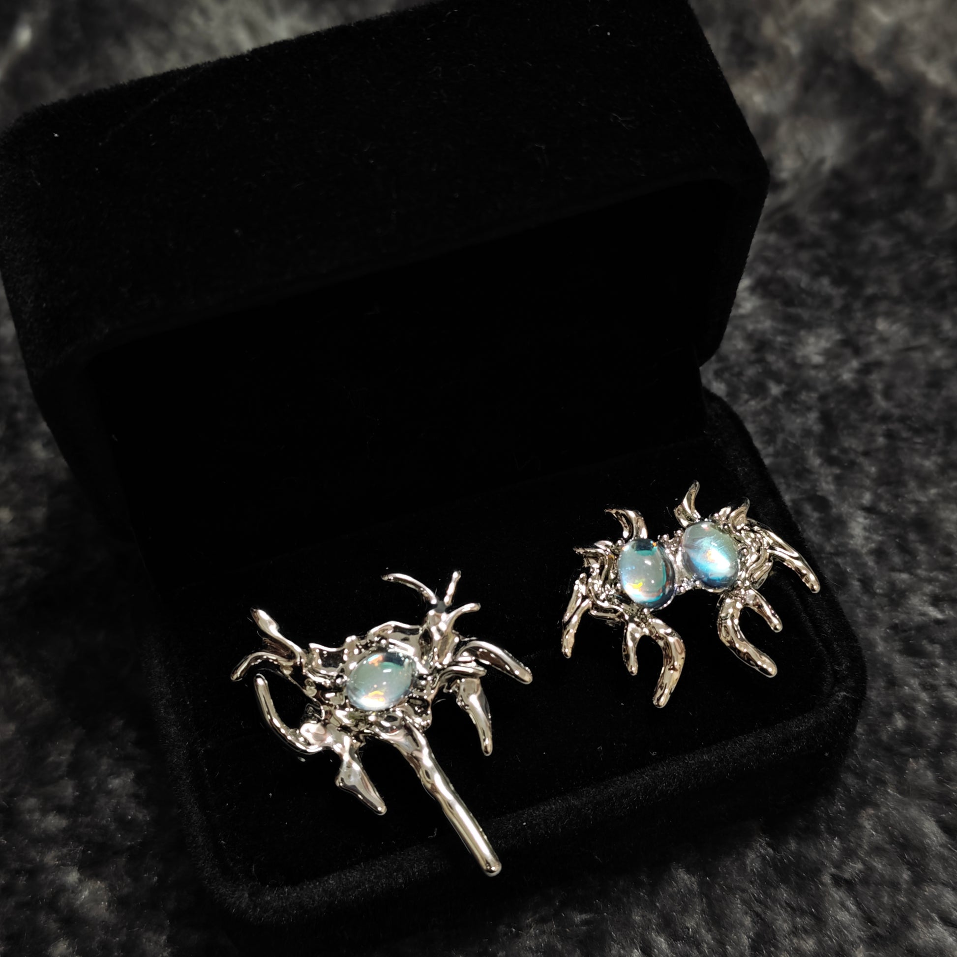 Monster Ring in open black velvet jewelry box, angled view
