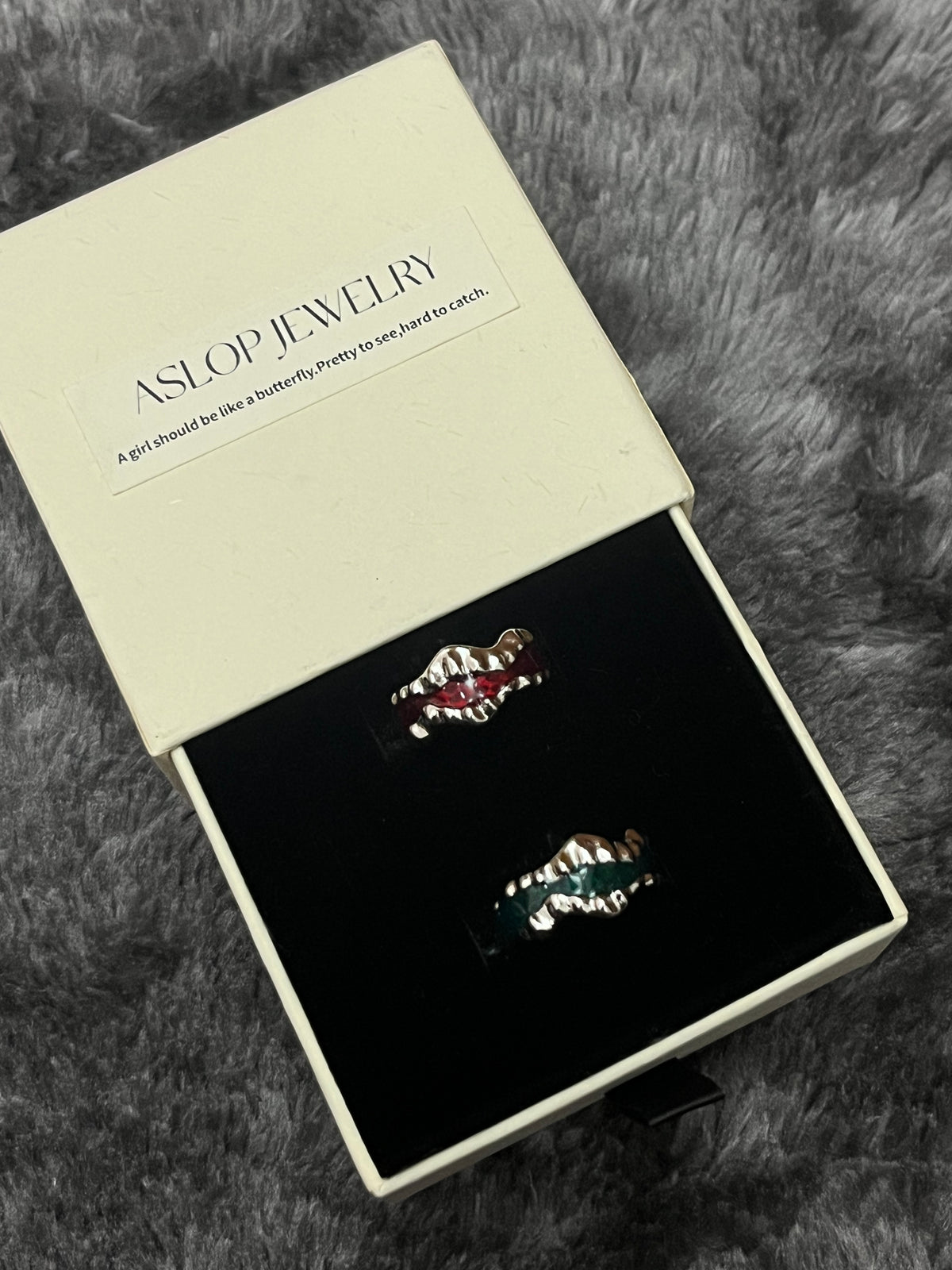 Drip Glaze Wave Ring in Red and Green colorways, wavy silver bands with drip-glaze enamel detail, in ASLOP TREASURE jewelry box