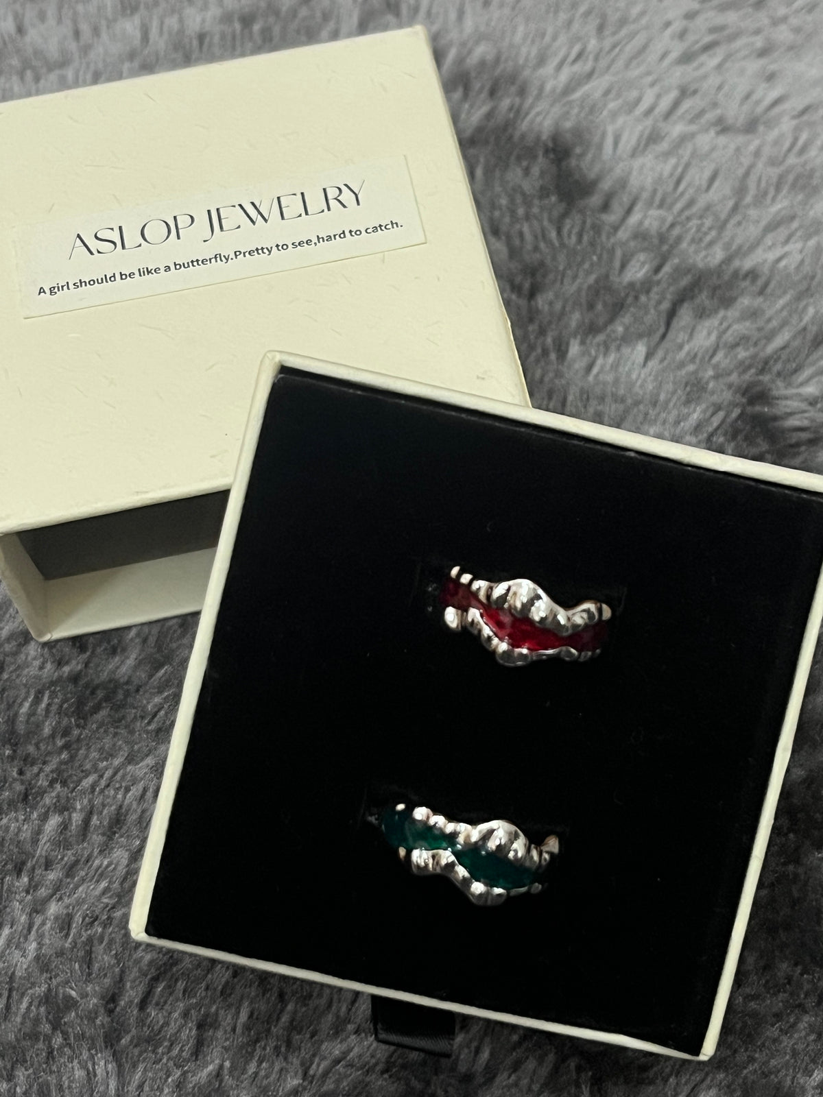 Drip Glaze Wave Ring, Red colorway close-up showing wavy silver band with red drip-glaze enamel