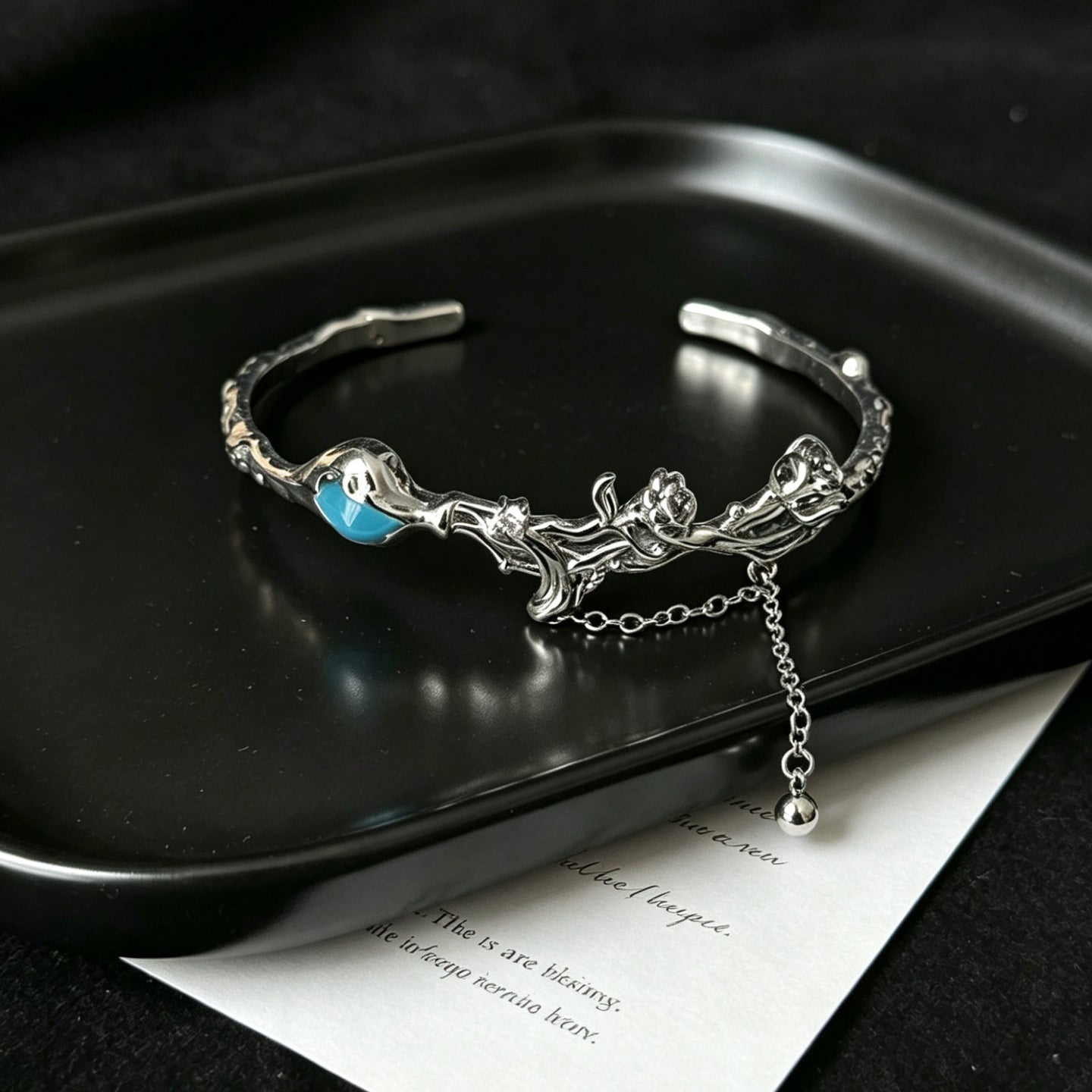 Silver open cuff bracelet with rose and thorn detailing
