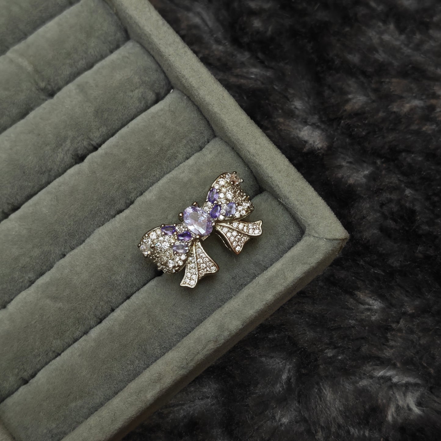 Individual whimsigoth ring shown alone on grey velvet display, detail product shot