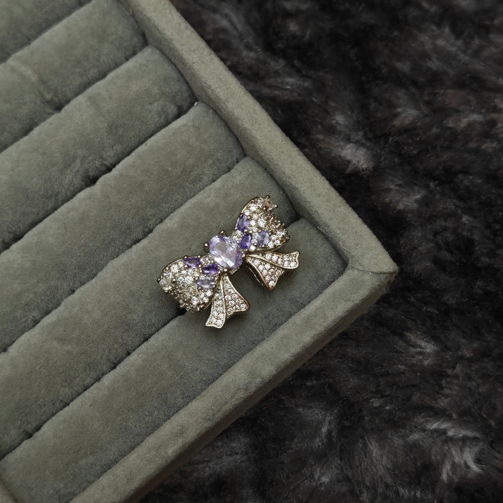 Individual whimsigoth ring shown alone on grey velvet display, detail product shot
