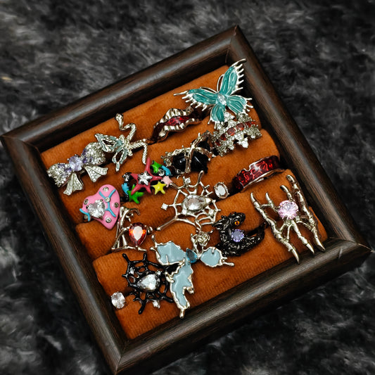 Standalone gothic statement rings on grey velvet tray
