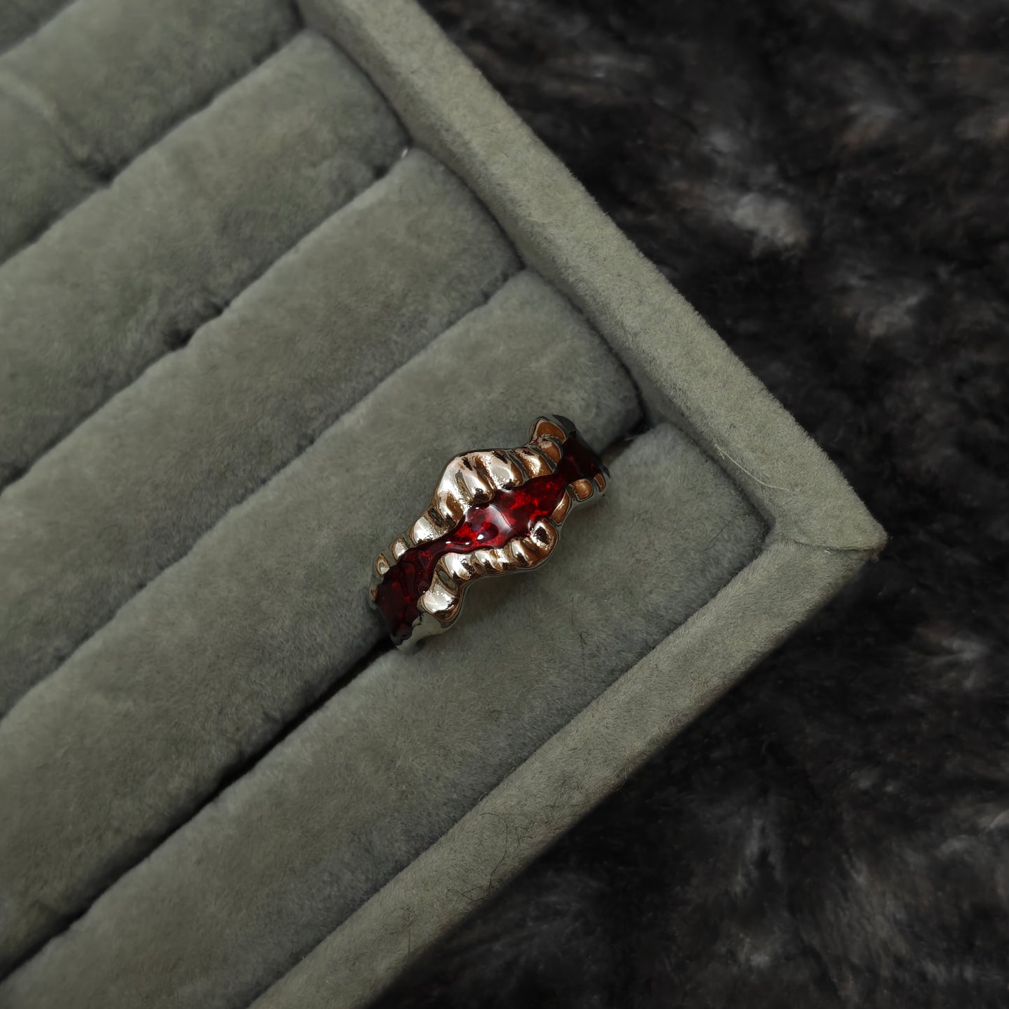  Individual Y2K-inspired ring shown alone on grey velvet display, detail product shot