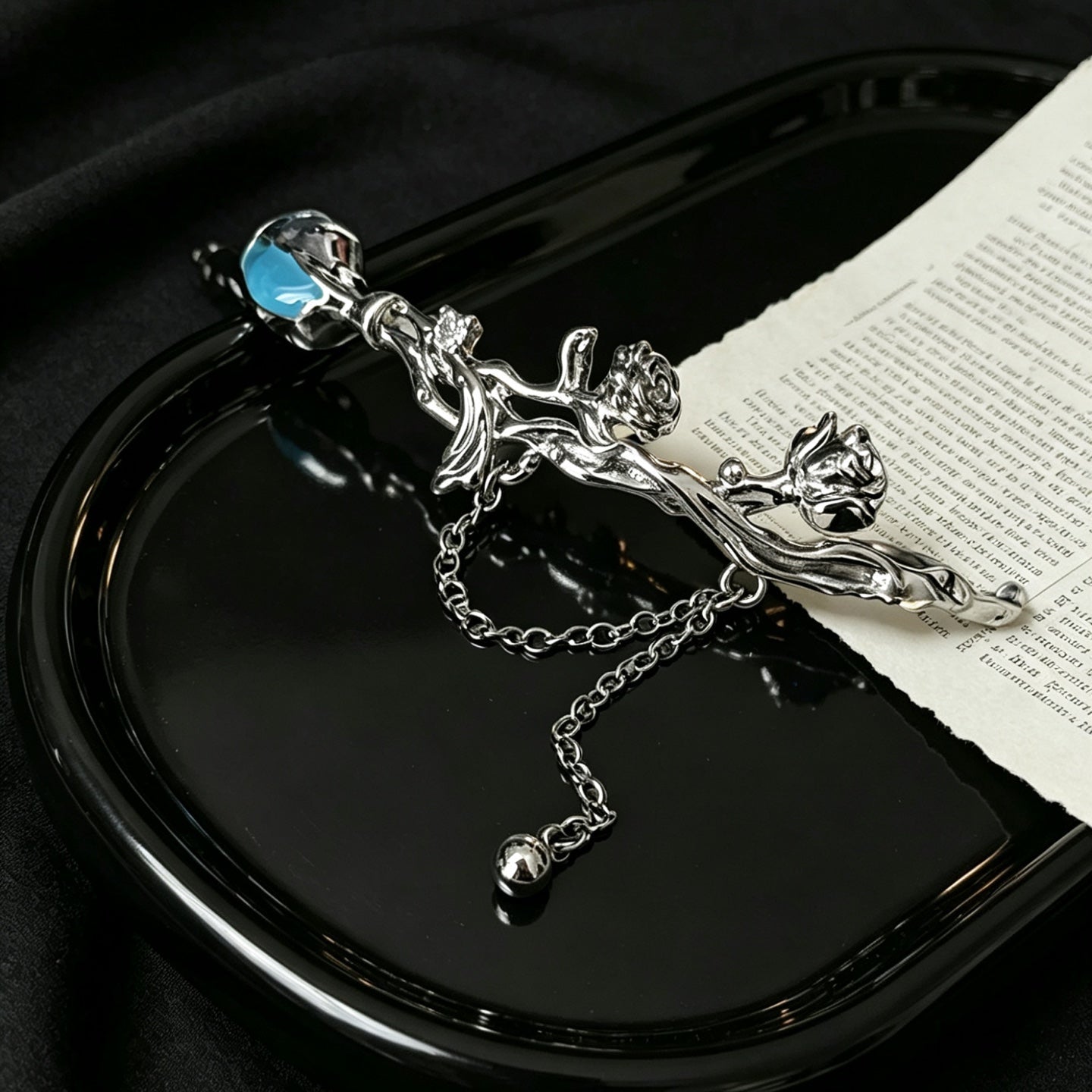 Silver sculptural rose and thorn branch cuff bracelet with chain drop, top view