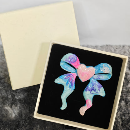 Marbled enamel bow ring pink and blue swirl detail