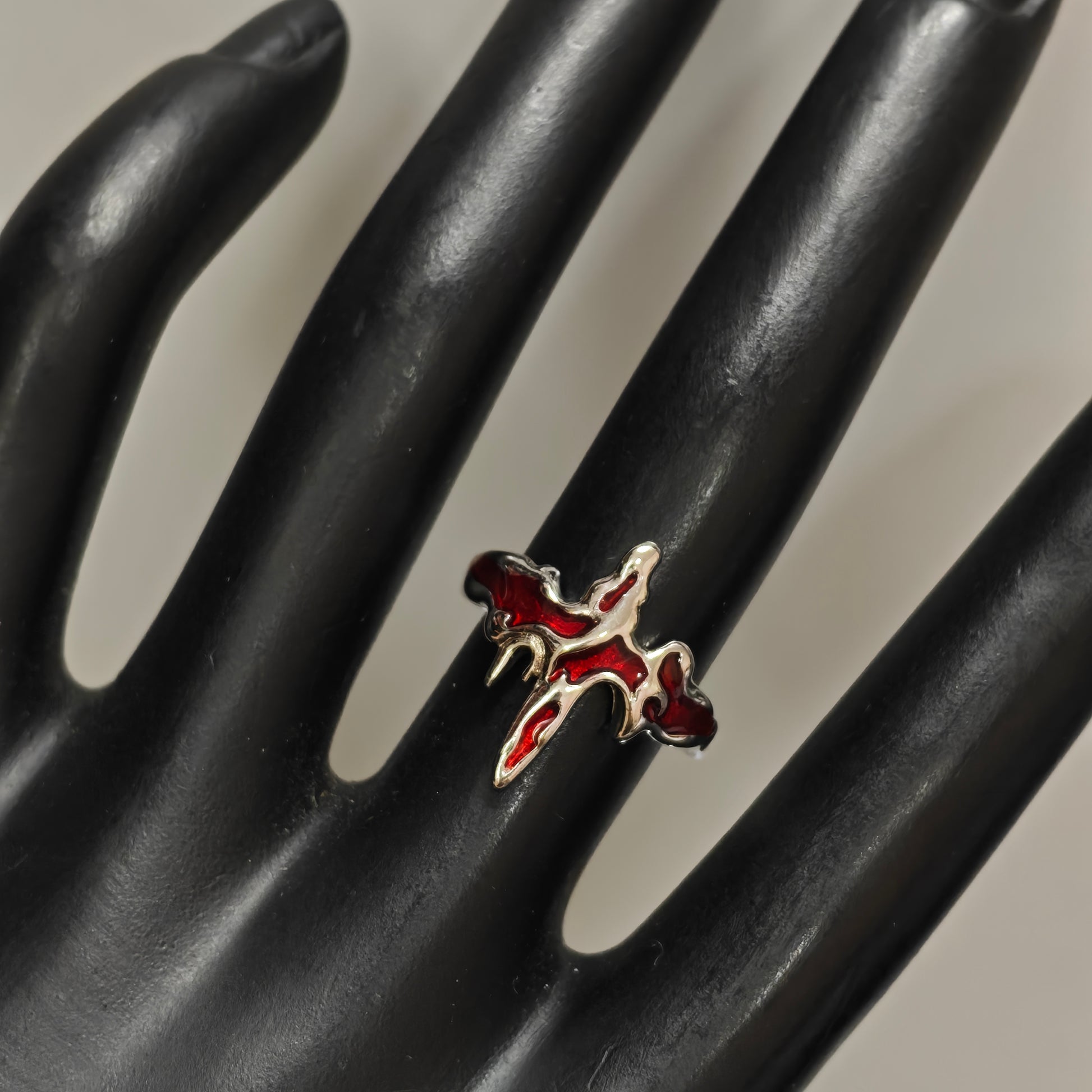 Gothic red enamel flaming cross ring close up