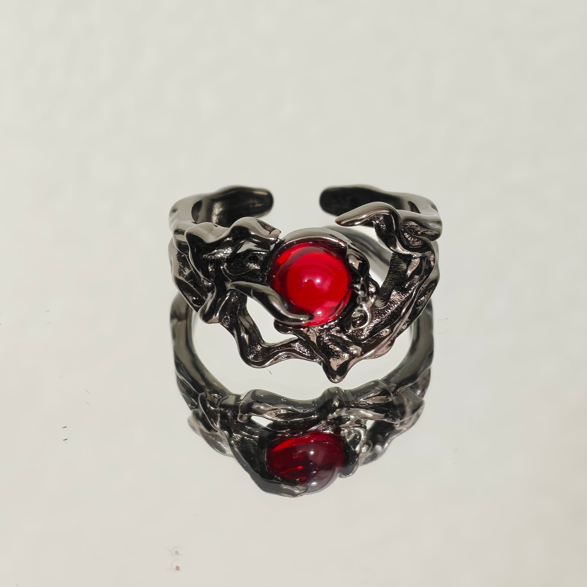 Gothic gunmetal ring with red cabochon stone