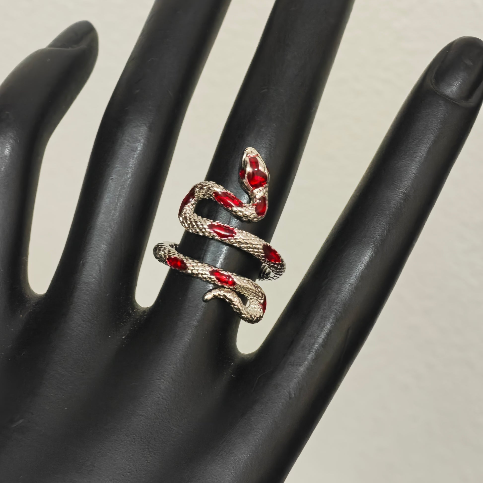 Silver snake ring wrapping around finger