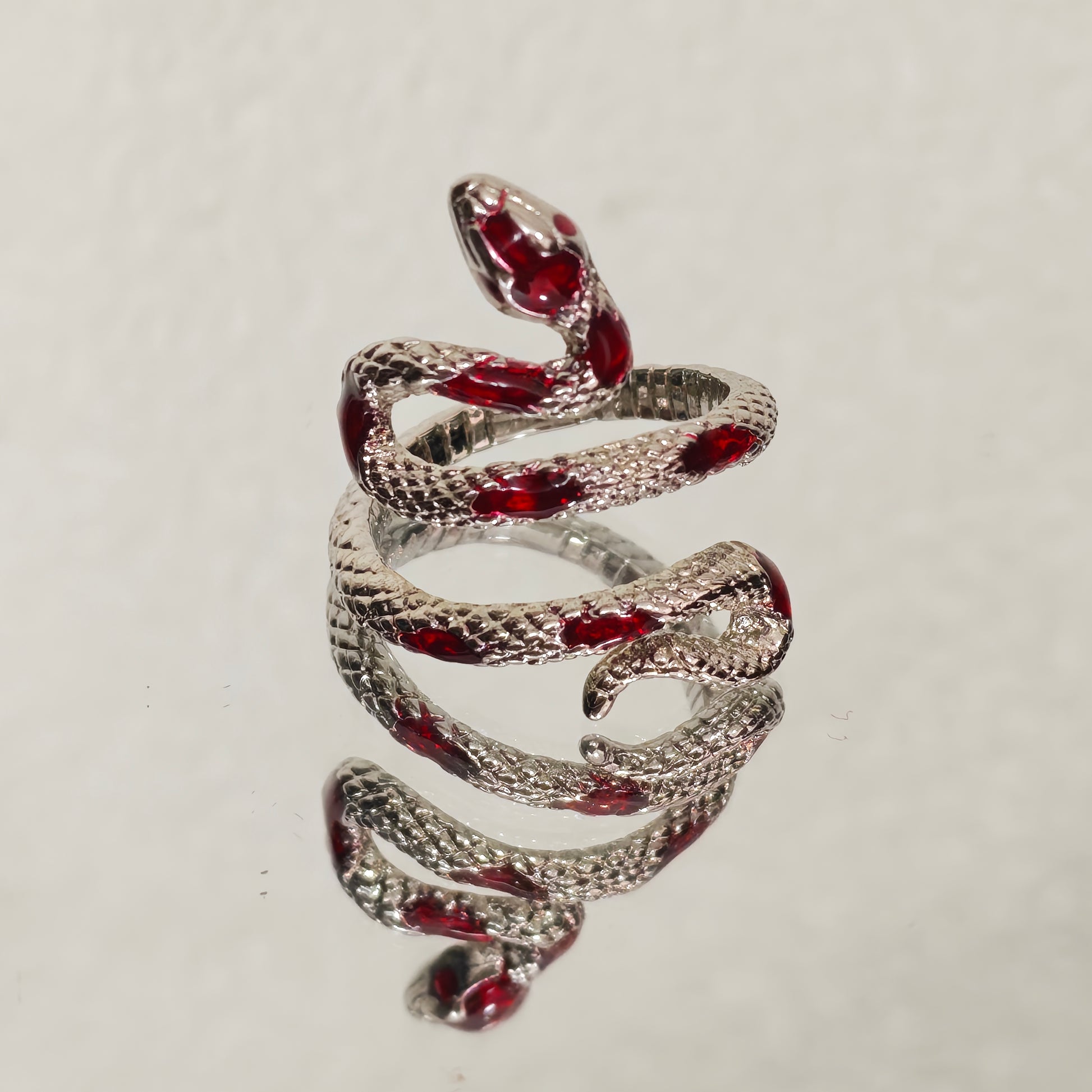 Adjustable silver snake wrap ring with red enamel scales