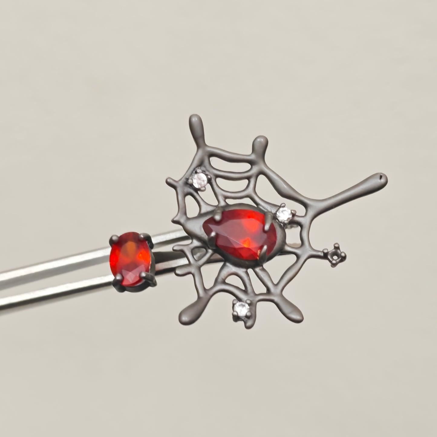 Adjustable gothic spider web ring with red teardrop stone