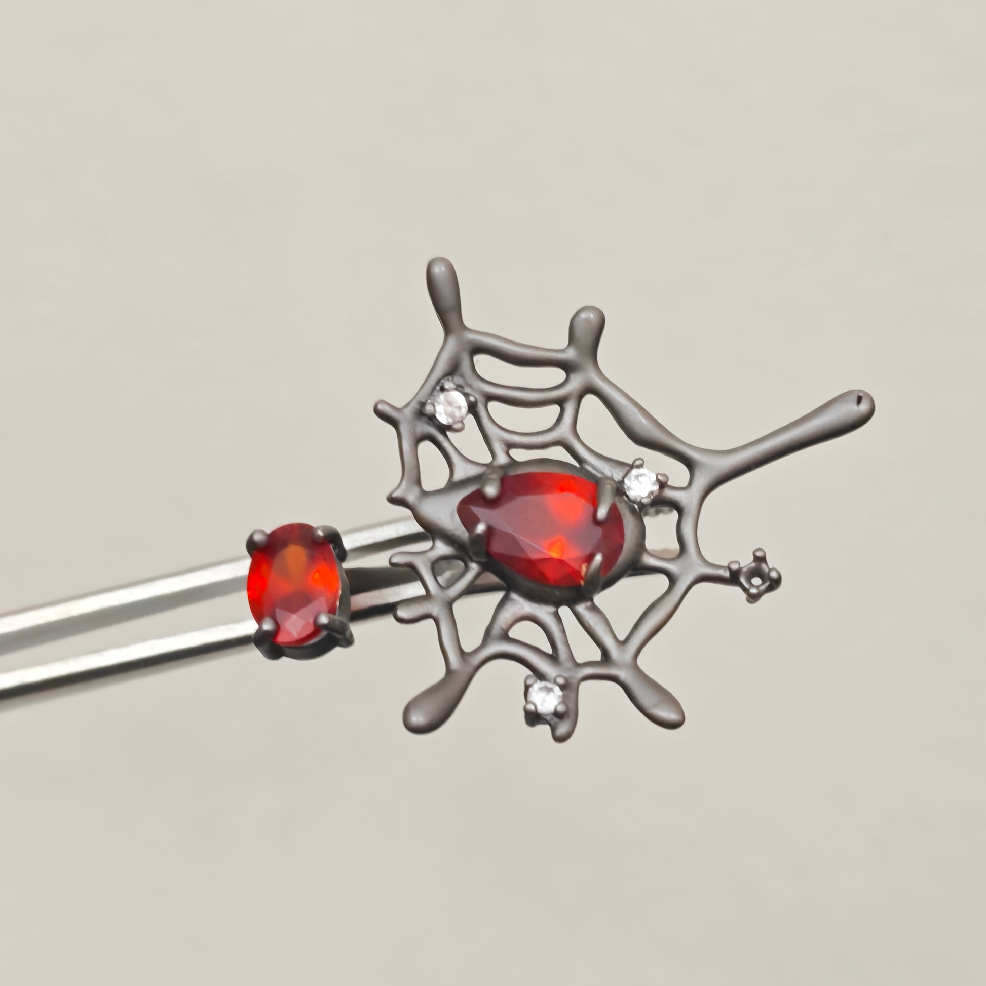 Adjustable gothic spider web ring with red teardrop stone