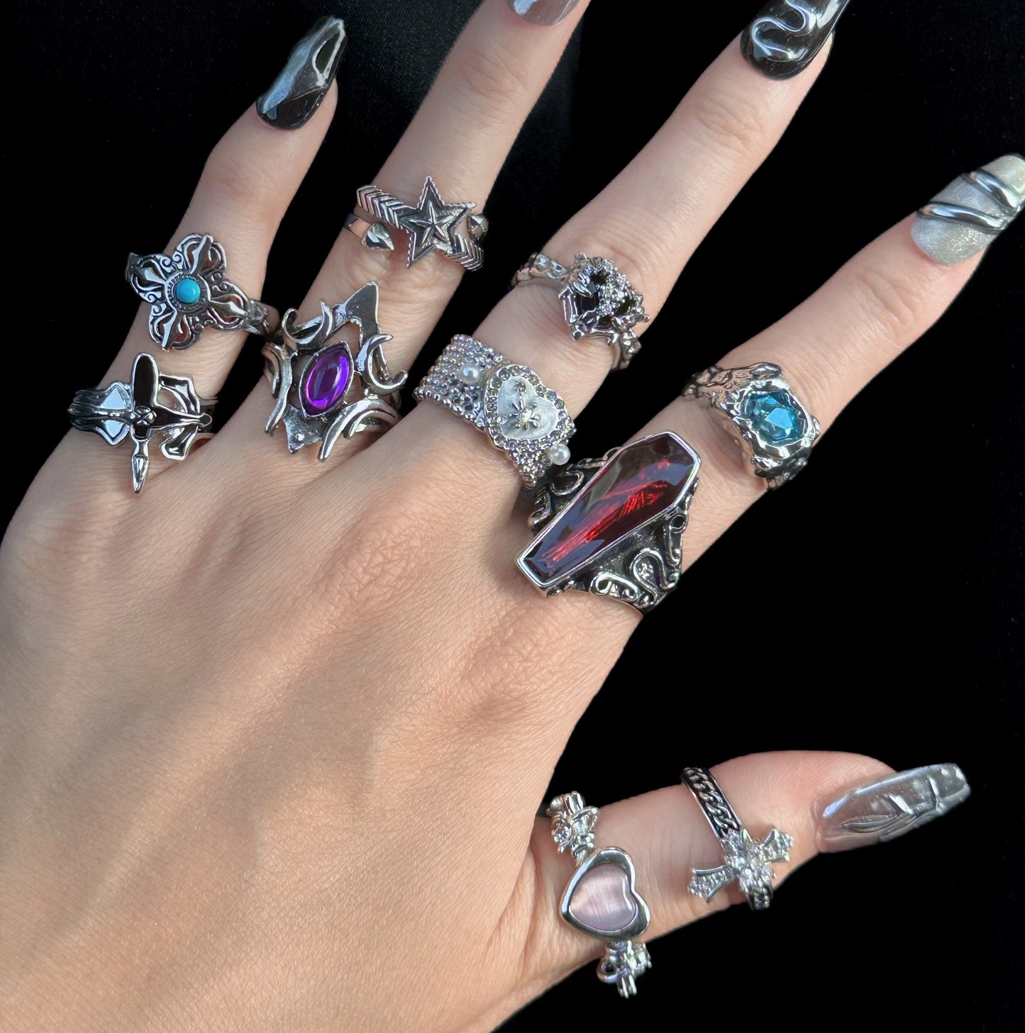 Collection of gothic and whimsigoth adjustable rings, vintage silver jewelry for dark coquette and alternative fashion.