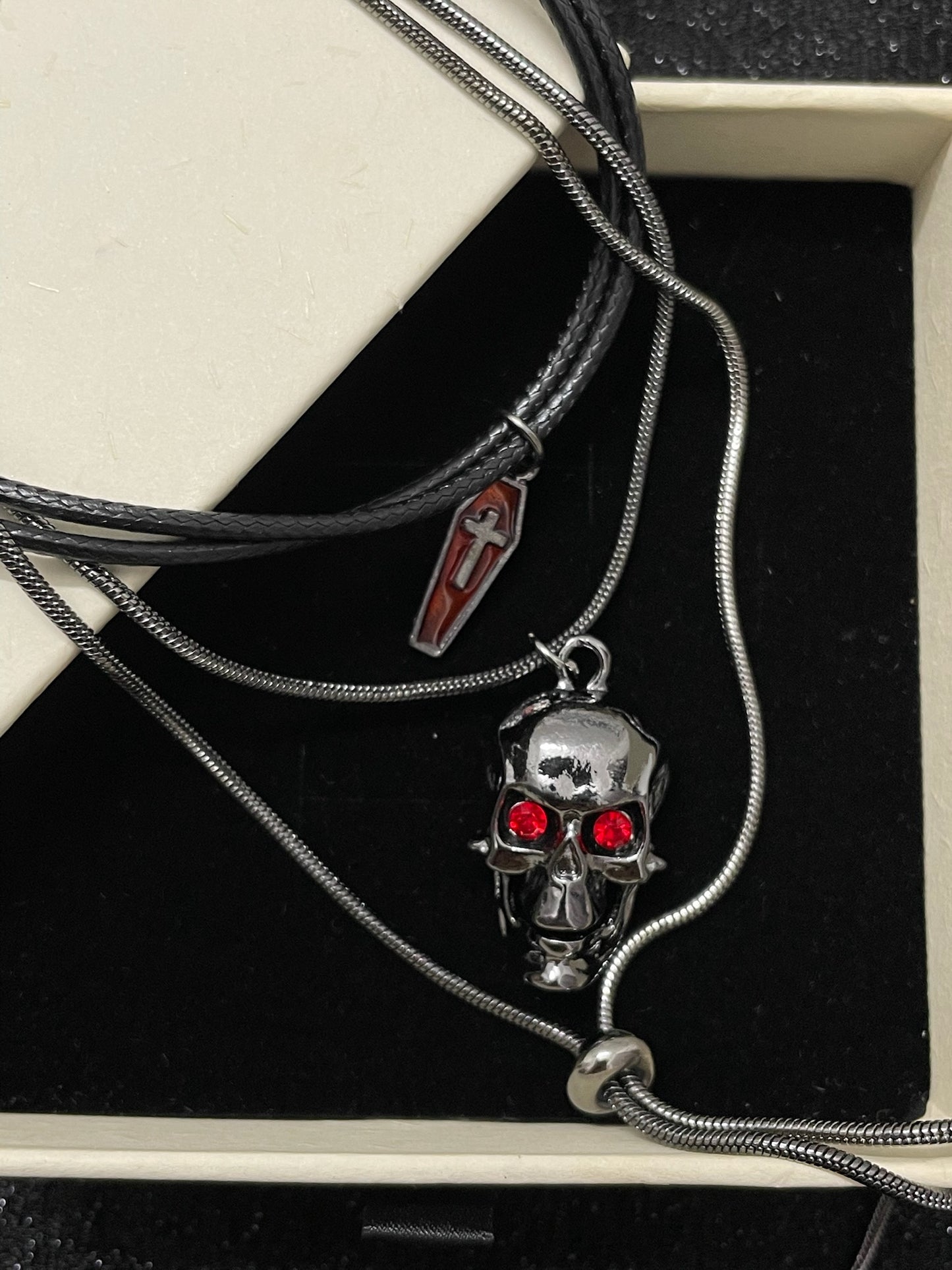 Gothic Red-Eyed Skull & Coffin Pendant Necklace - Dark Aesthetic Grunge Jewelry in open Aslop Jewelry white gift box, angled view