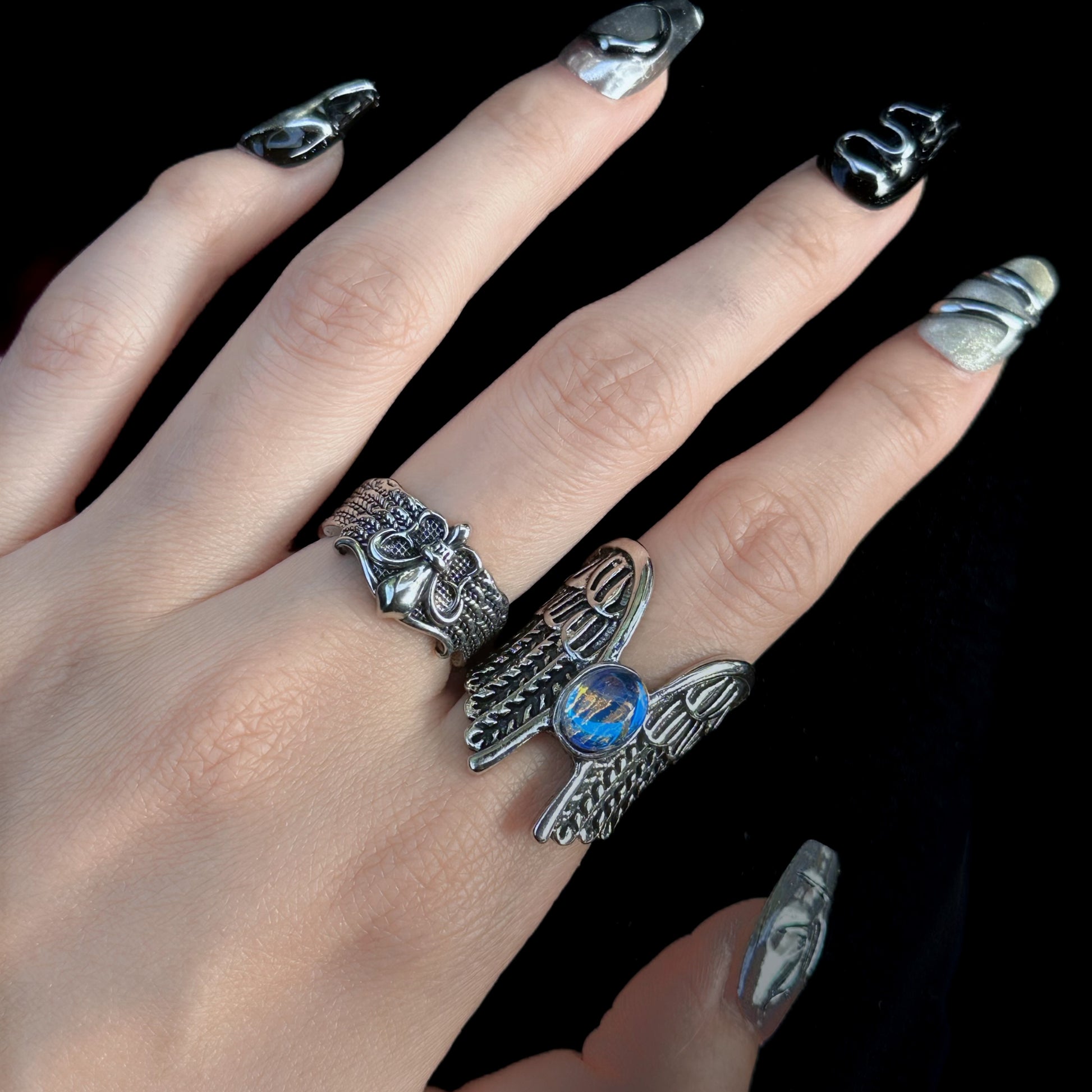 Guardian of the Dark Fallen Angel Wing Ring Set in open black velvet jewelry box, overhead flat lay