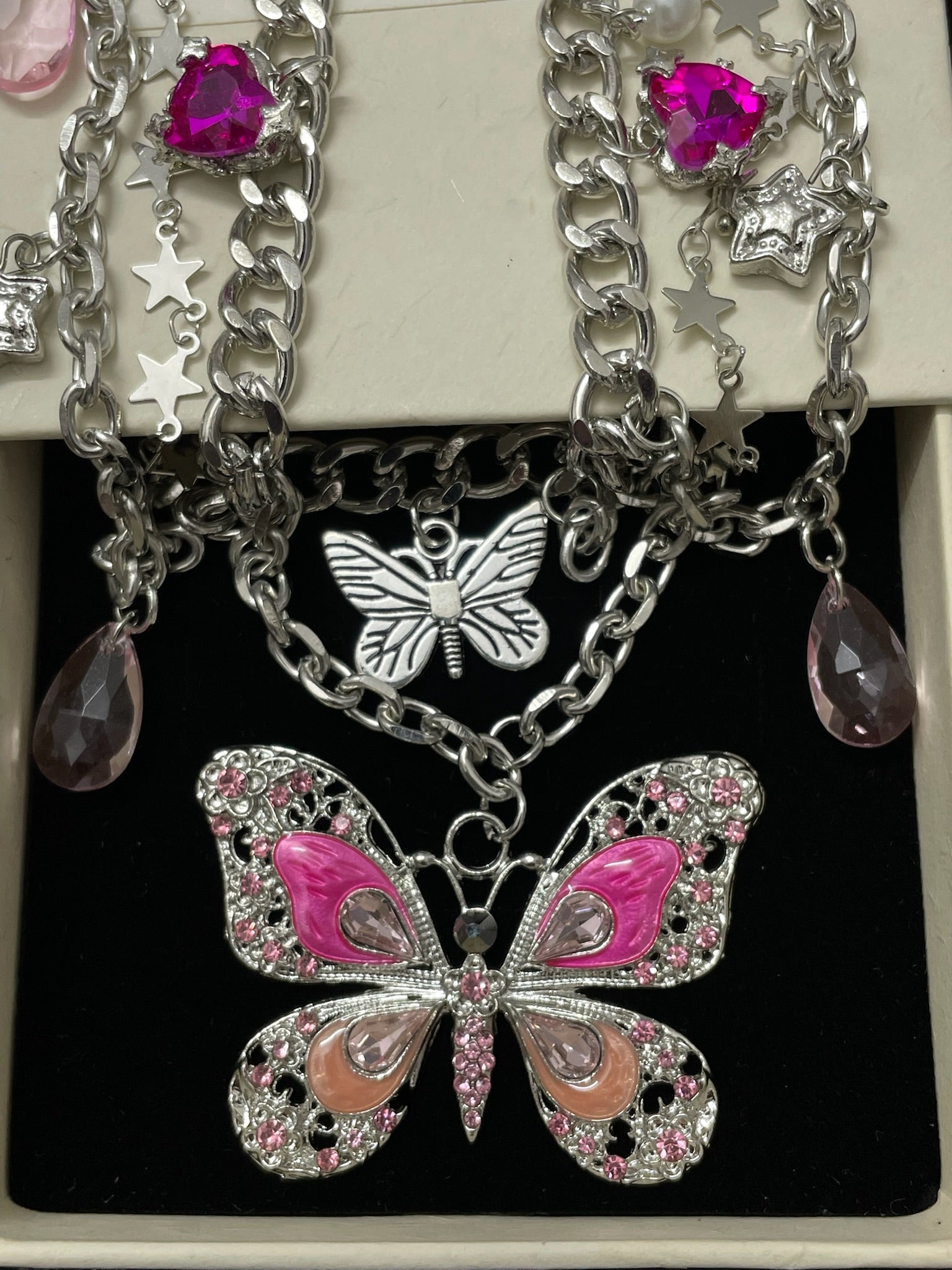Pink Butterfly Charm Necklace in open Aslop Jewelry white gift box, overhead flat view