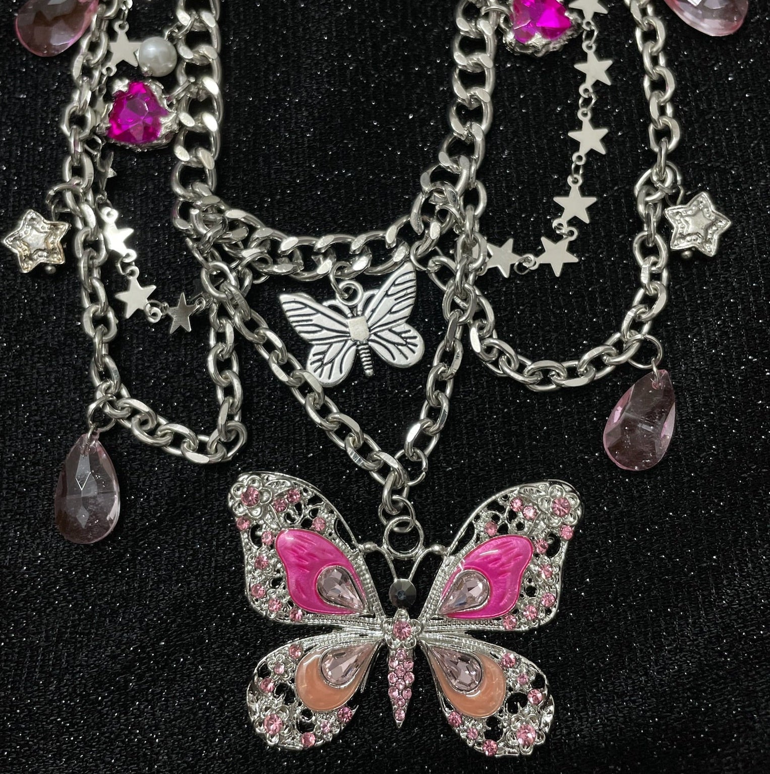 Pink Butterfly Charm Necklace on mannequin bust, front view close-up