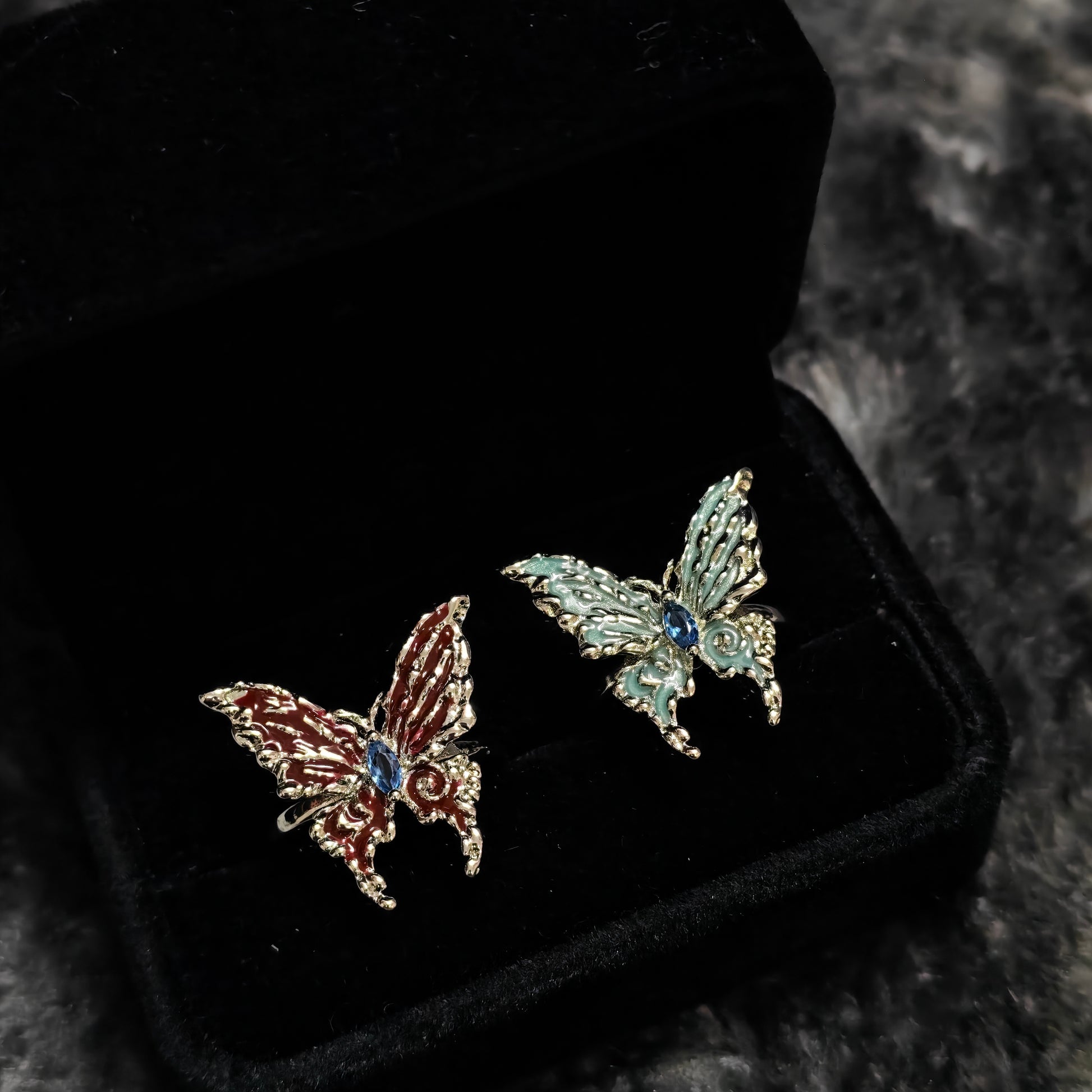 Red Enamel Butterfly Ring in open black velvet jewelry box, angled view