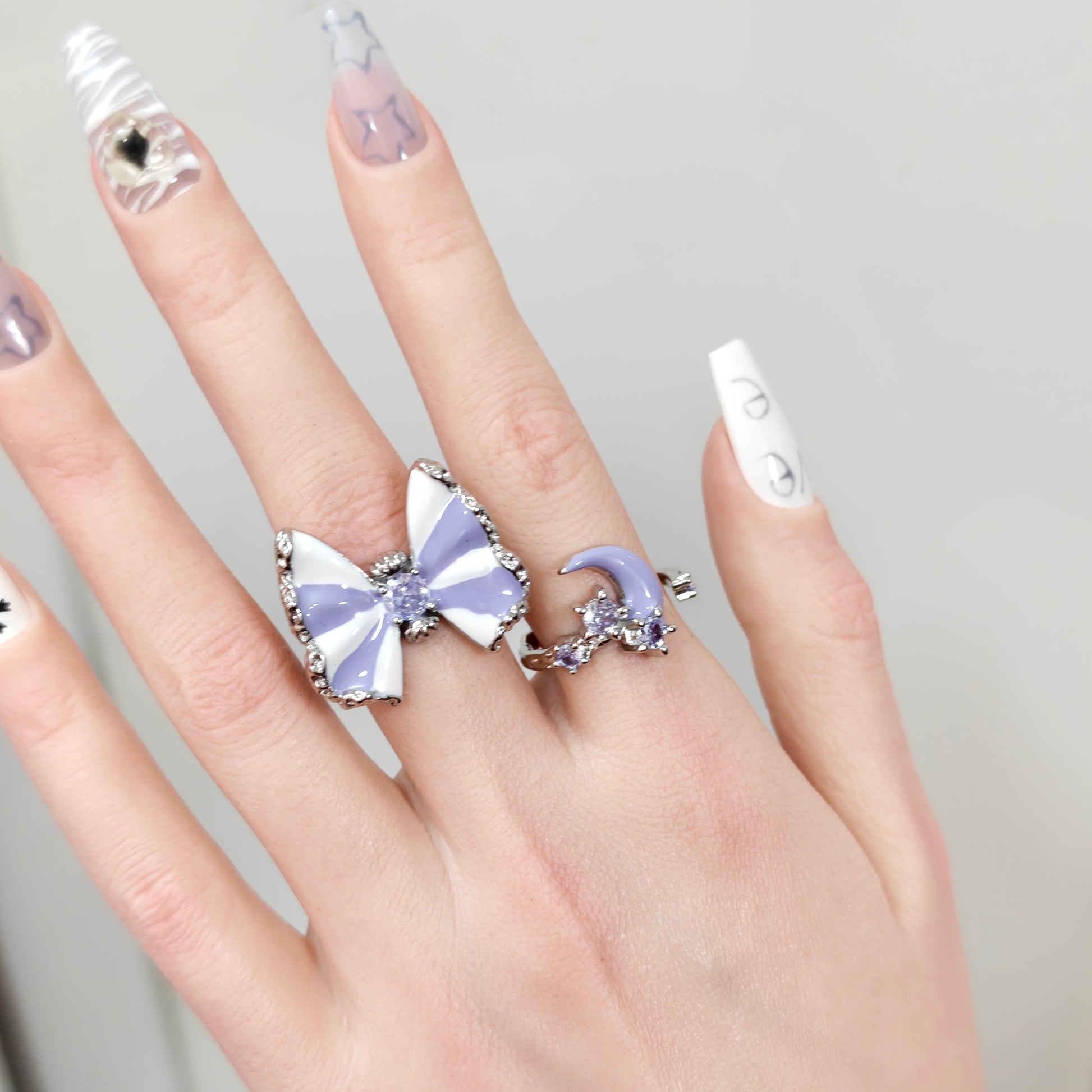 Butterfly & Moon Ring Set in open black velvet jewelry box, angled view