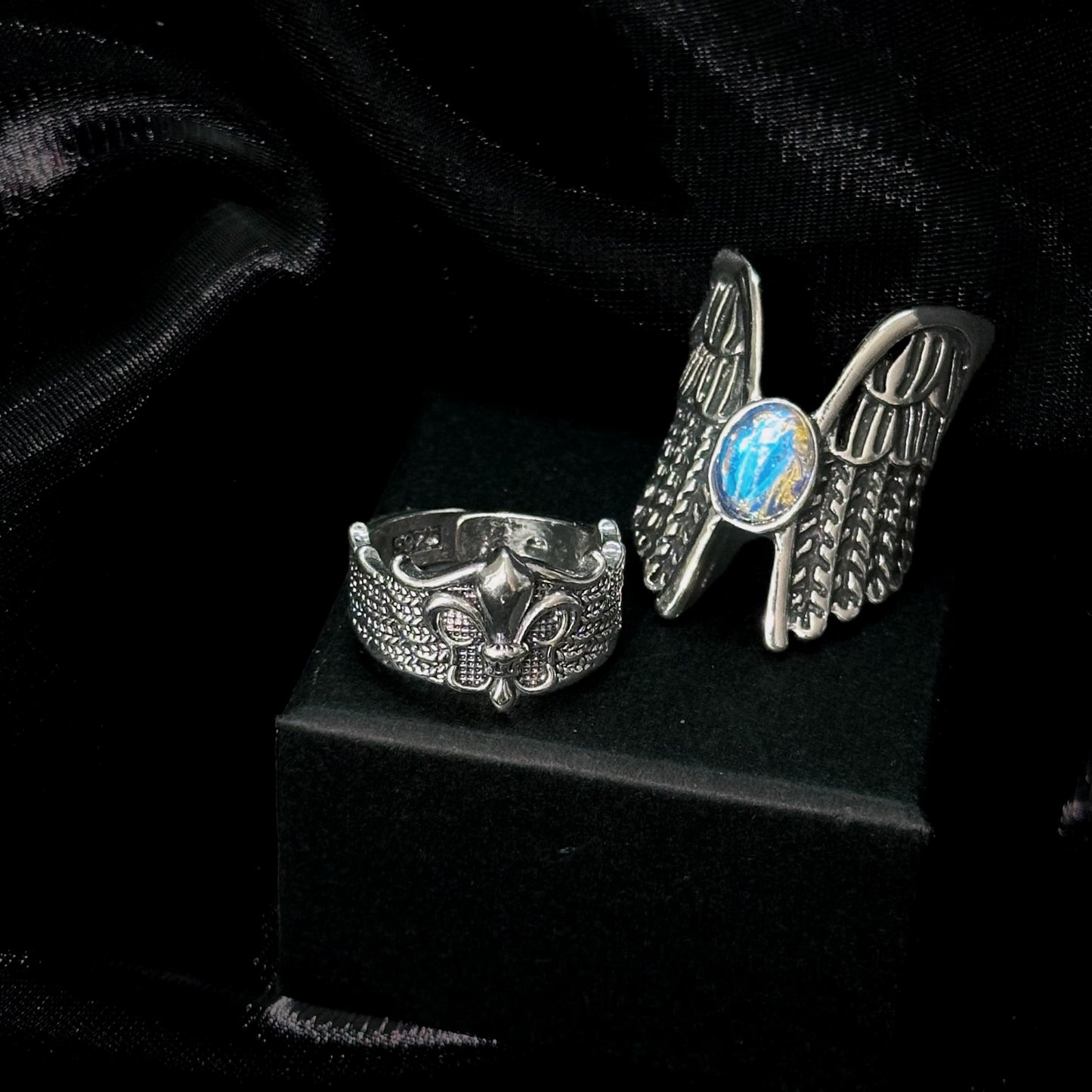 Guardian of the Dark Fallen Angel Wing Ring Set on black mannequin hand, front view close-up