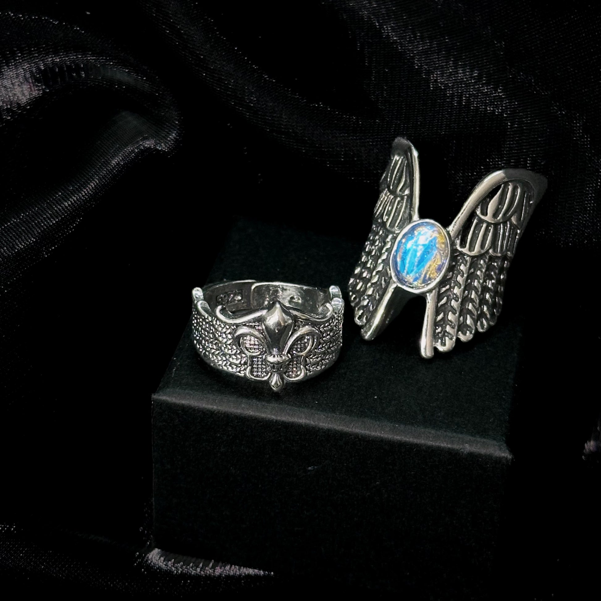Guardian of the Dark Fallen Angel Wing Ring Set on black mannequin hand, front view close-up