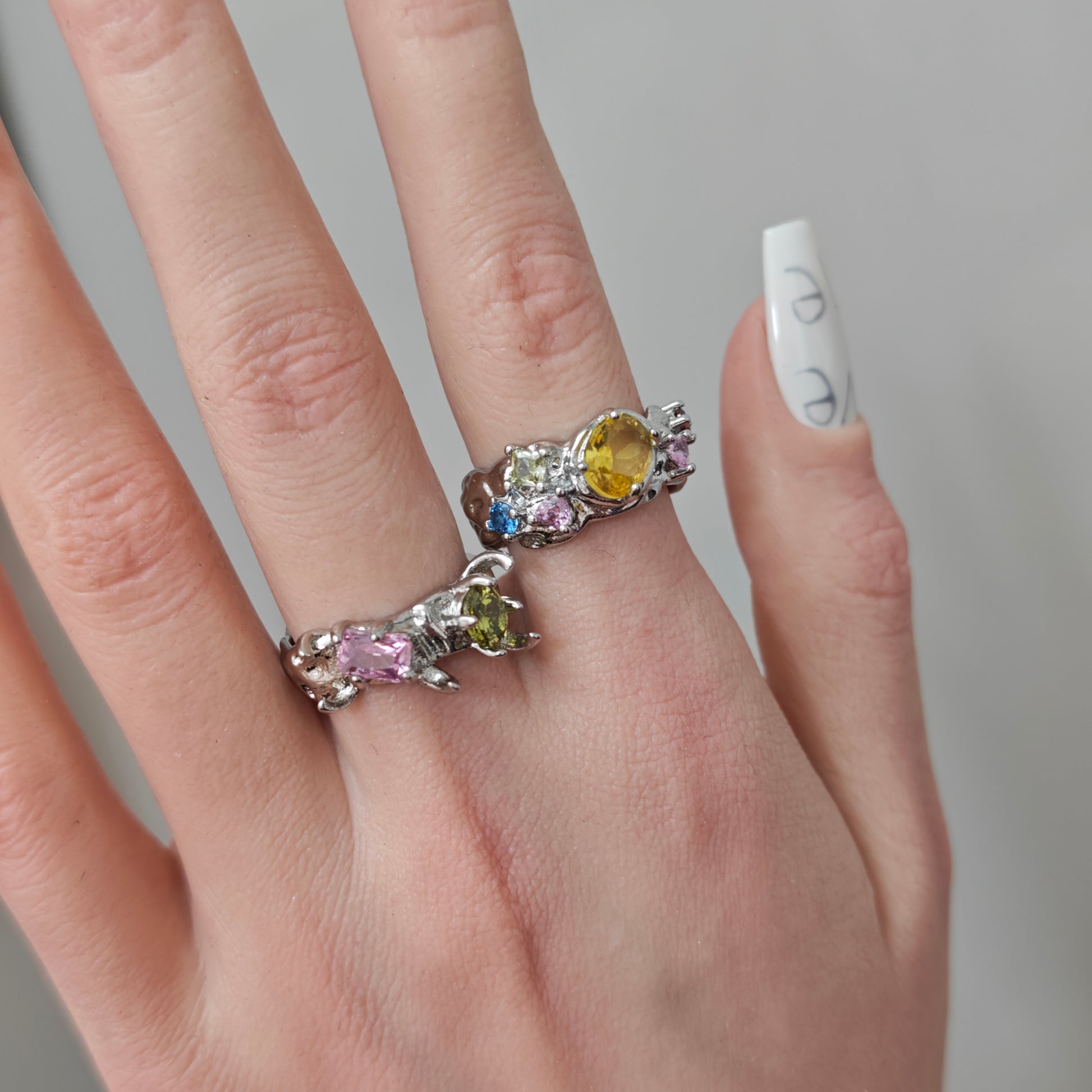 Colorful Zircon Claw Ring in open black velvet jewelry box, overhead flat lay