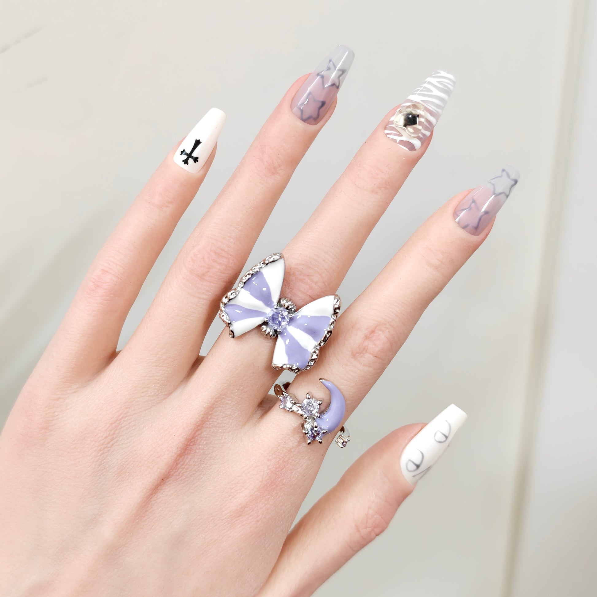 Butterfly & Moon Ring Set on black mannequin hand, front view close-up