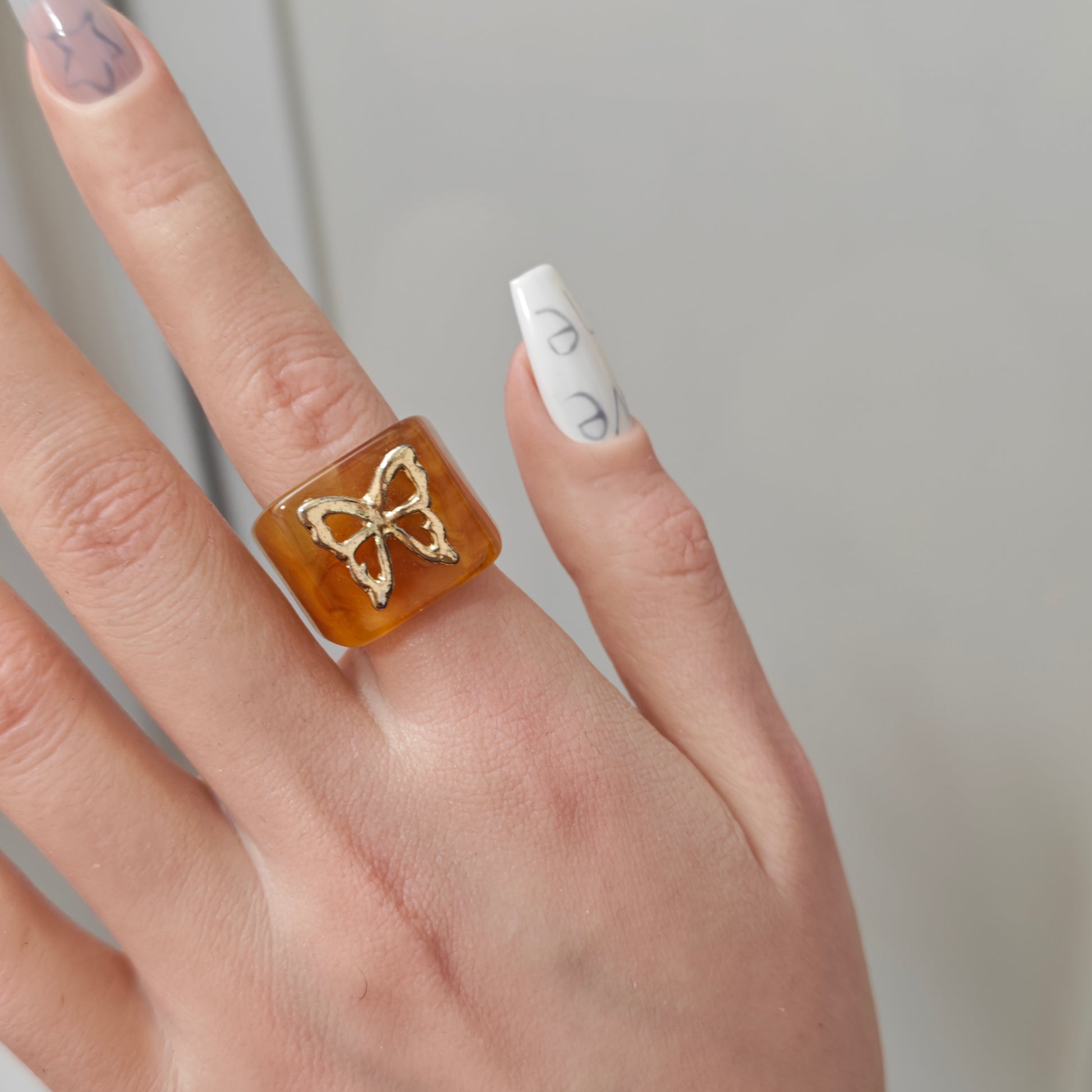 Amber Butterfly Resin Ring detail view 1, amber finish alternative dark aesthetic