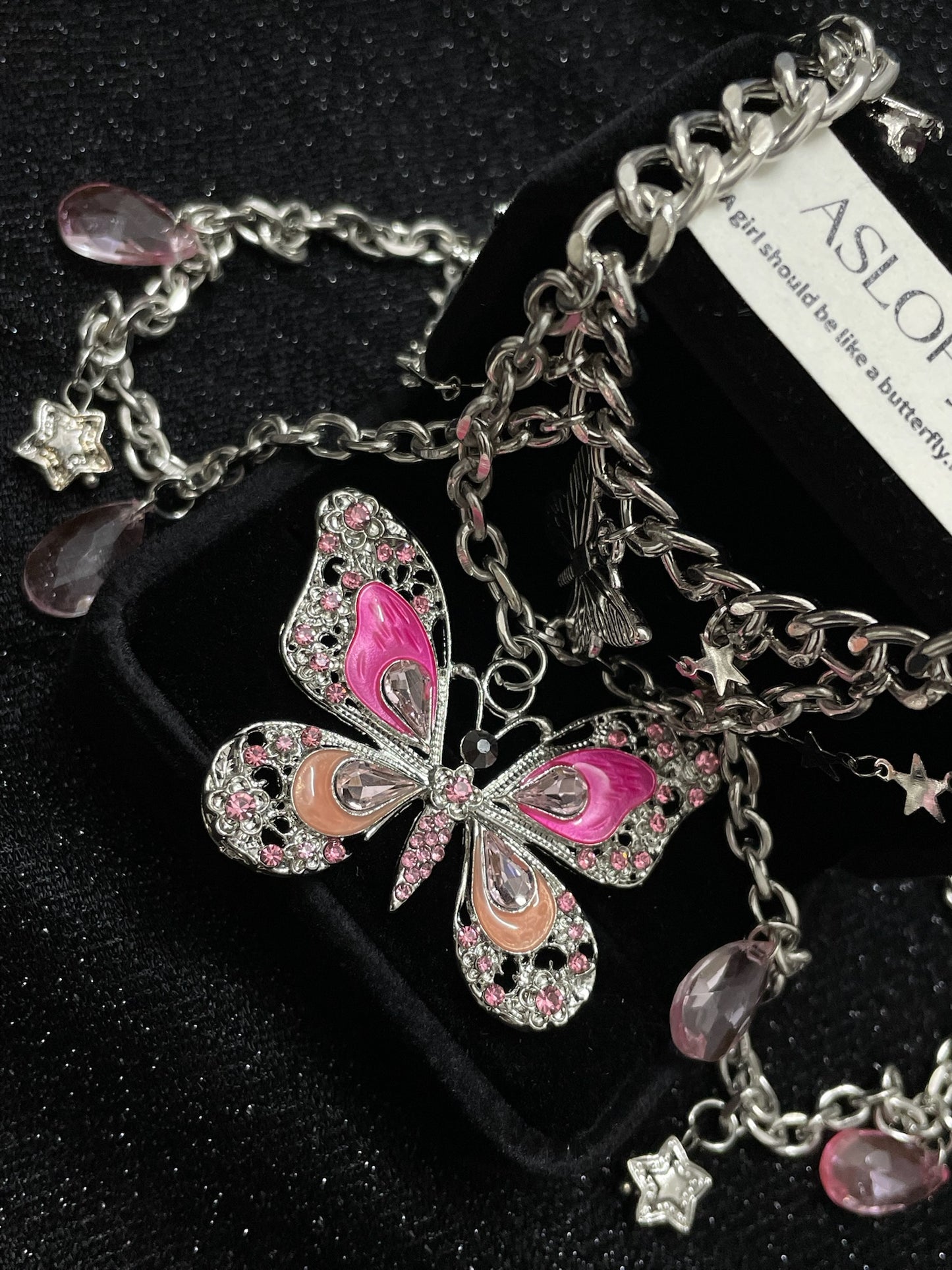Pink Butterfly Charm Necklace in open Aslop Jewelry white gift box, angled view