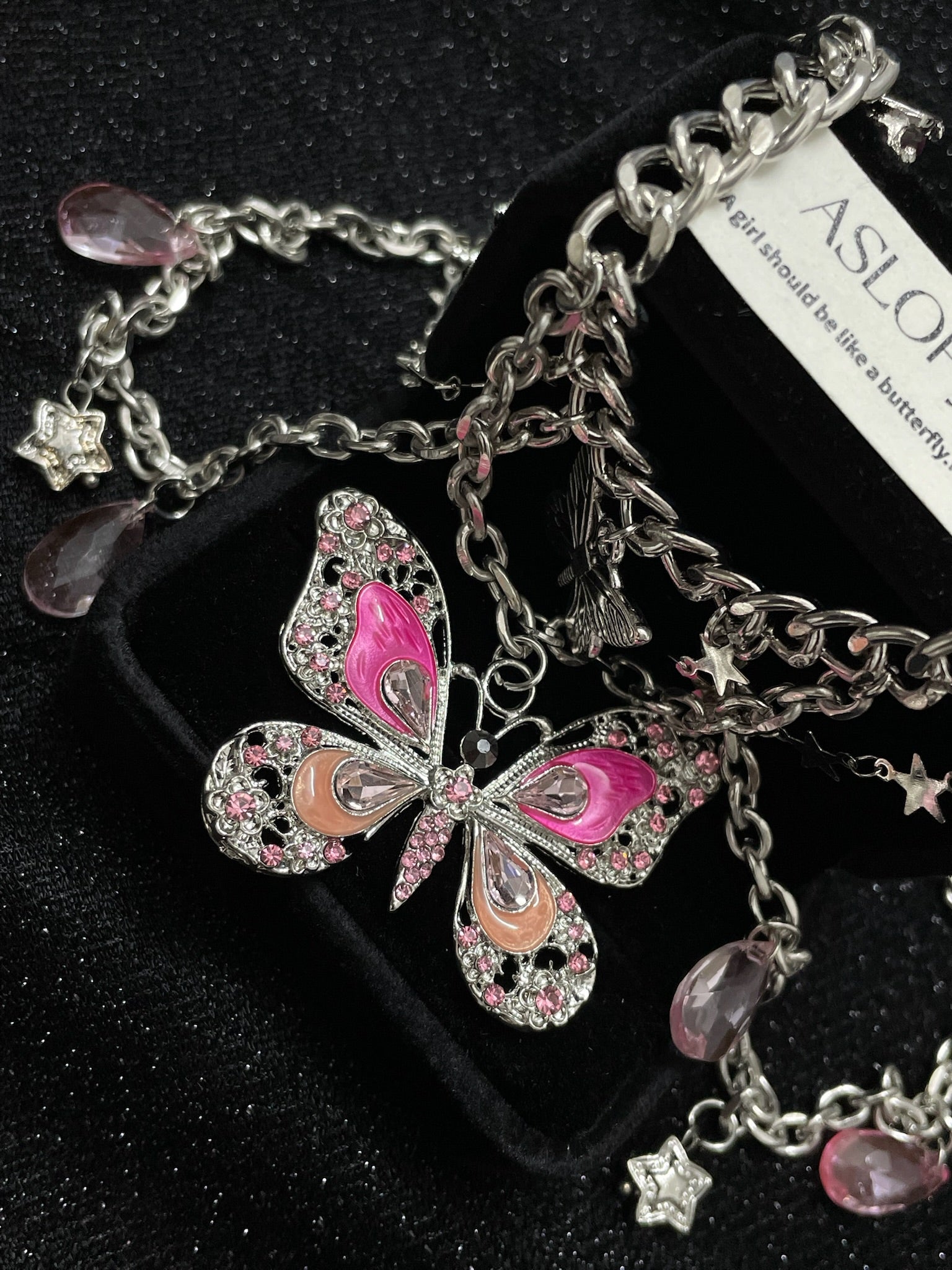 Pink Butterfly Charm Necklace in open Aslop Jewelry white gift box, angled view