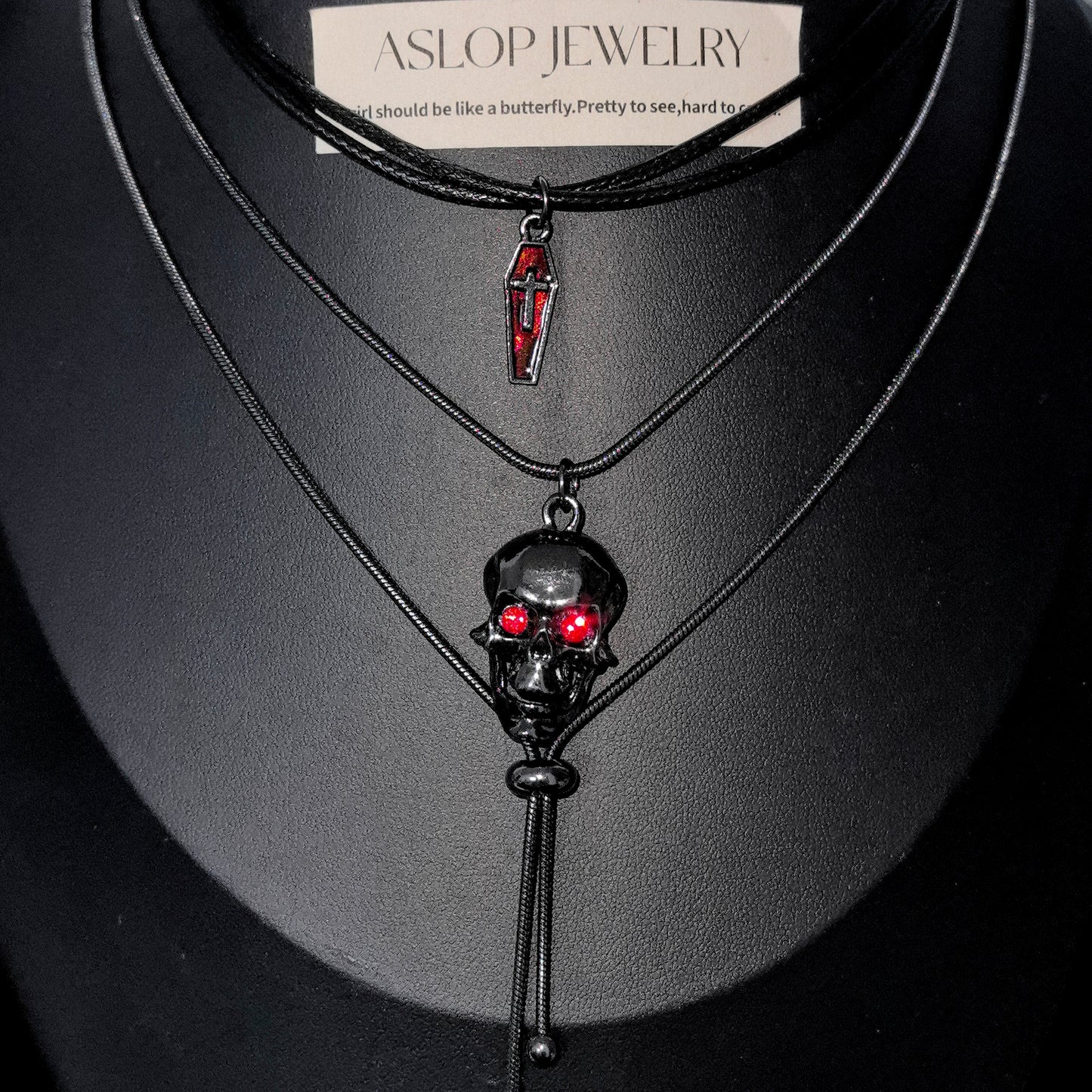 Gothic Red-Eyed Skull & Coffin Pendant Necklace - Dark Aesthetic Grunge Jewelry on mannequin bust, front view close-up