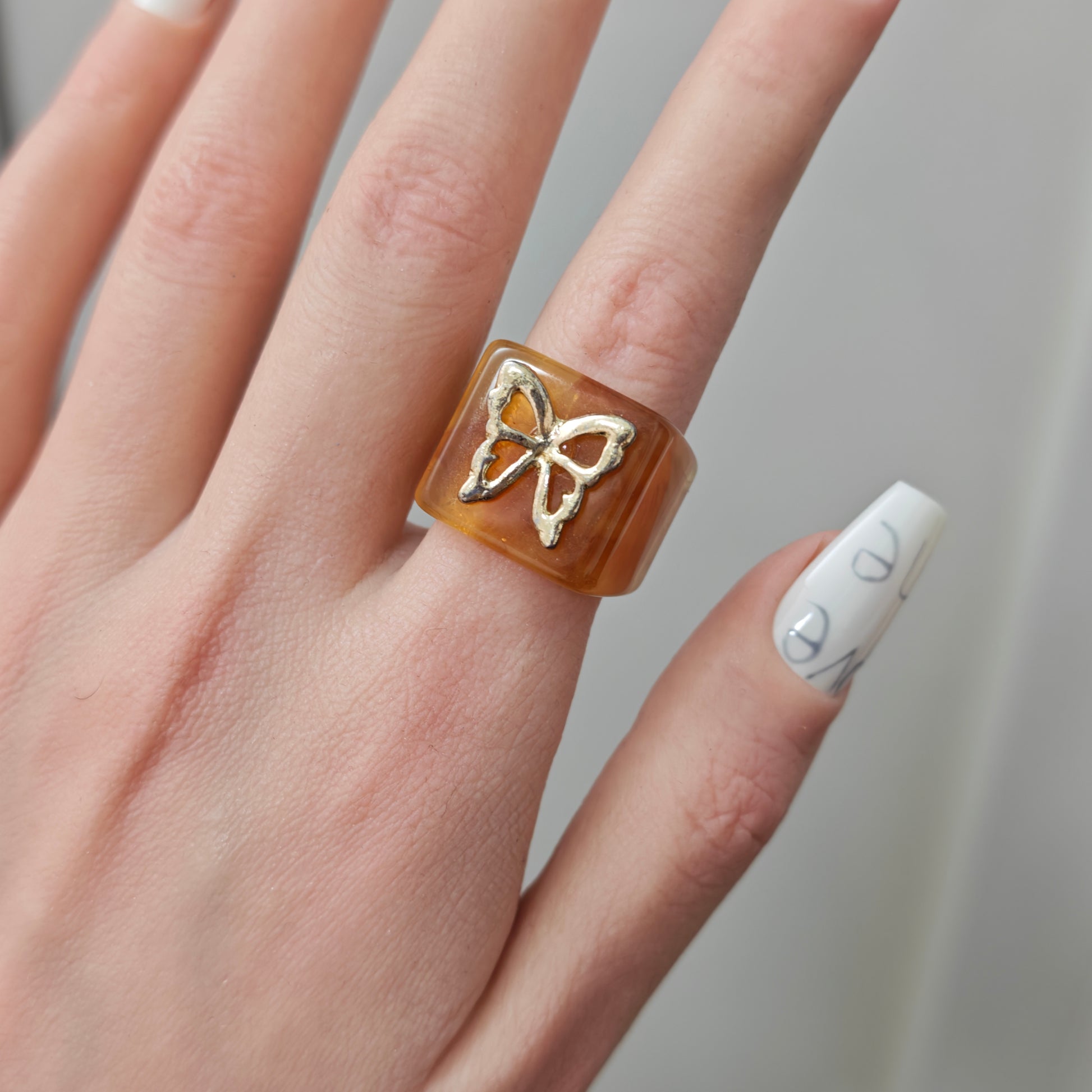 Amber Butterfly Resin Ring in open Aslop Jewelry white gift box, overhead flat view