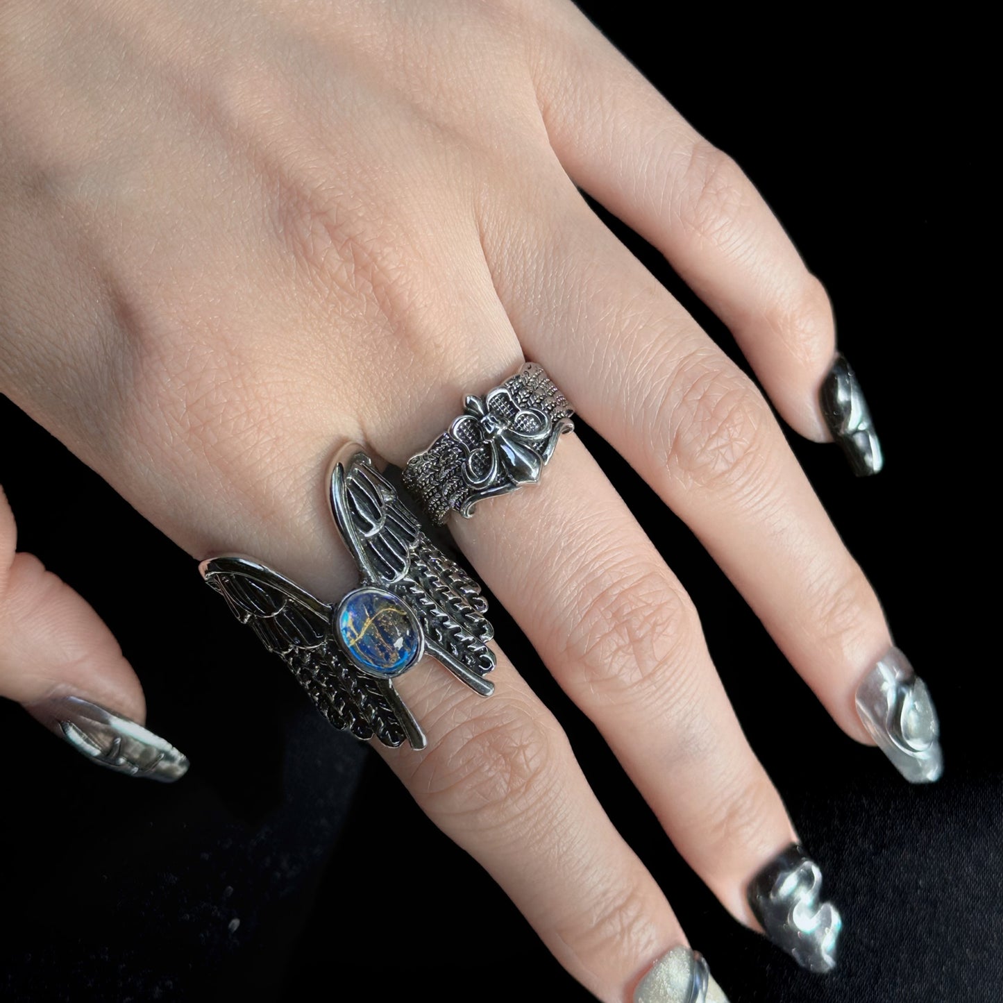 Guardian of the Dark Fallen Angel Wing Ring Set in open black velvet jewelry box, angled view
