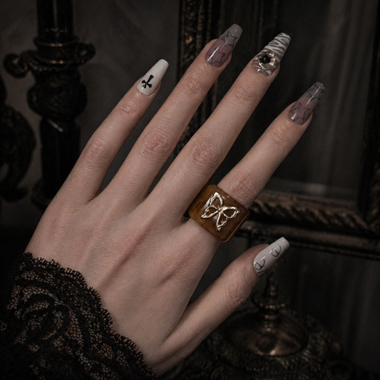 Amber Butterfly Resin Ring worn on finger, dark moody background – Aslop Treasure
