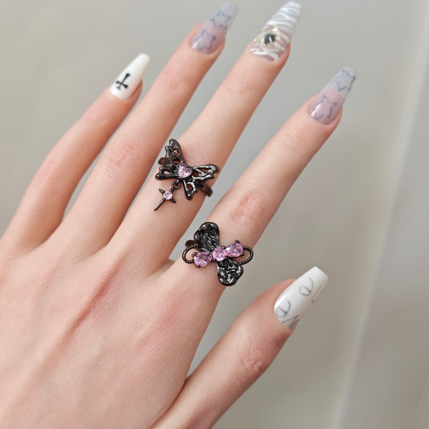 Pink Flutter Duo Adjustable Butterfly Heart & Crystal Stacking Rings close-up detail view showing pink finish