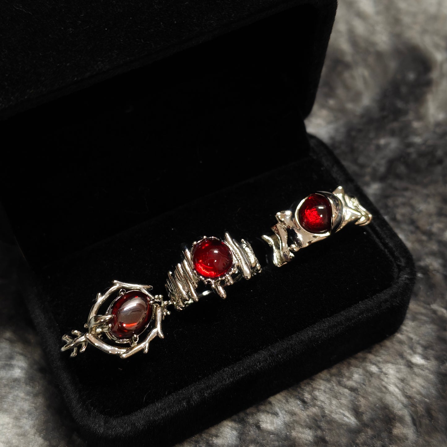Red Cabochon Dark Silver Ring Set in open black velvet jewelry box, overhead flat lay