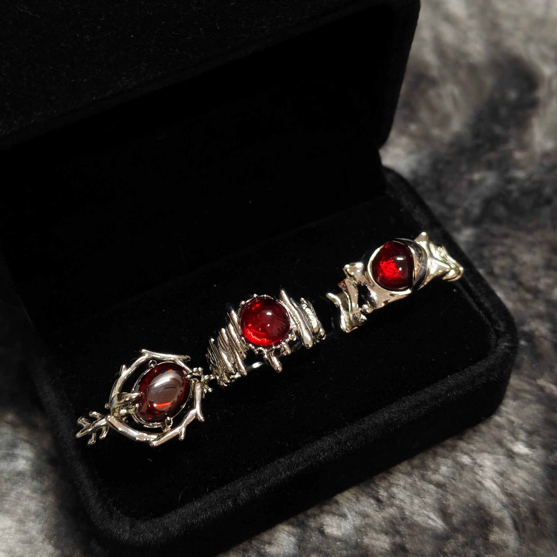 Red Cabochon Dark Silver Ring Set in open black velvet jewelry box, overhead flat lay