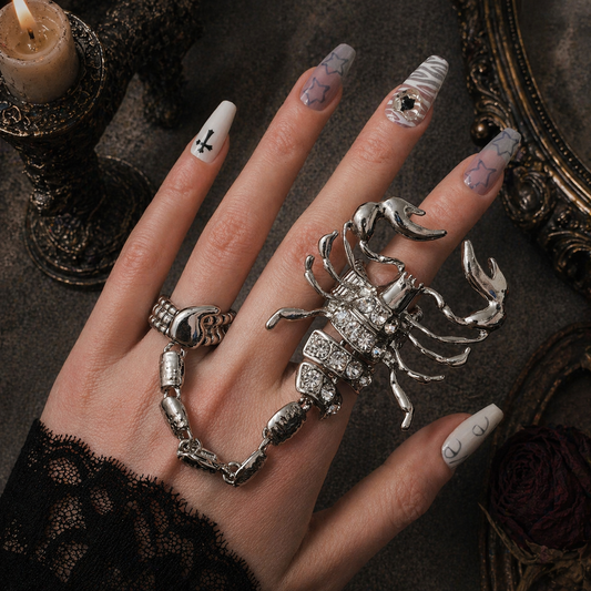 Scorpion Ring worn on finger, dark moody background – Aslop Treasure