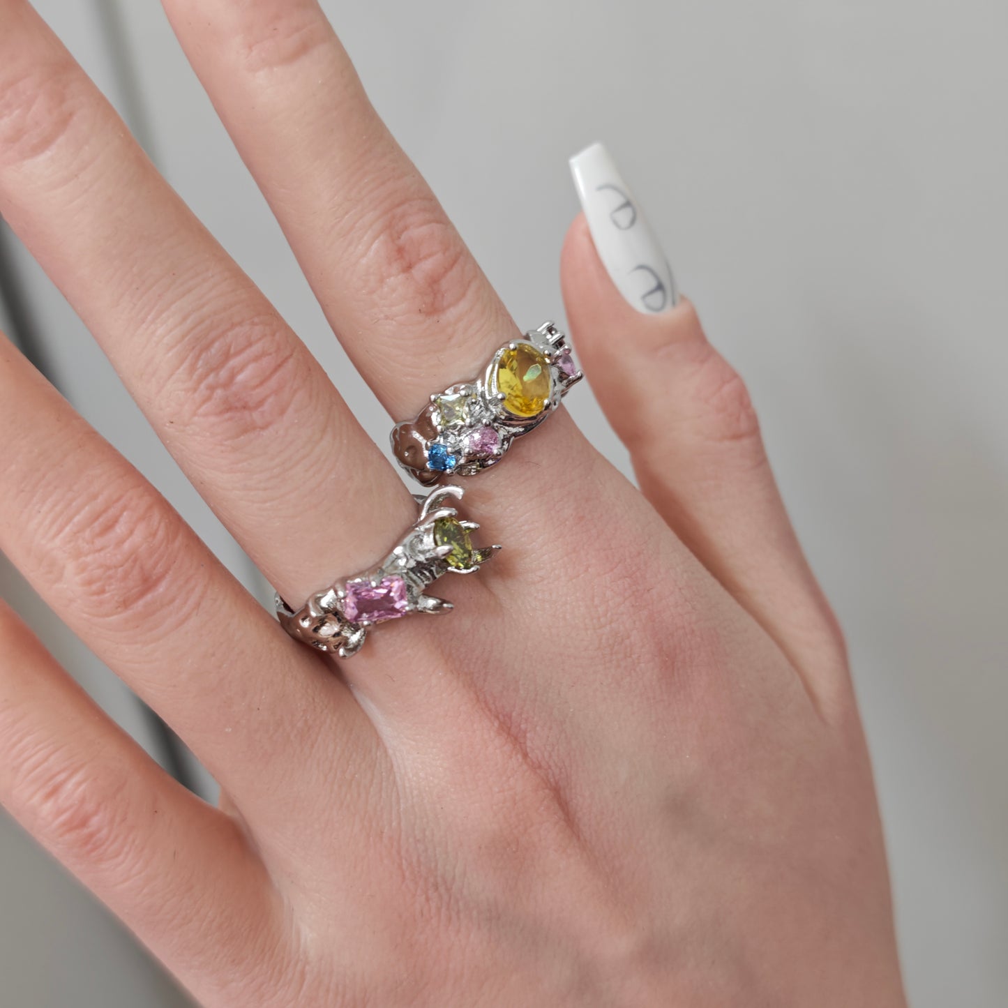 Colorful Zircon Claw Ring on black mannequin hand, front view close-up