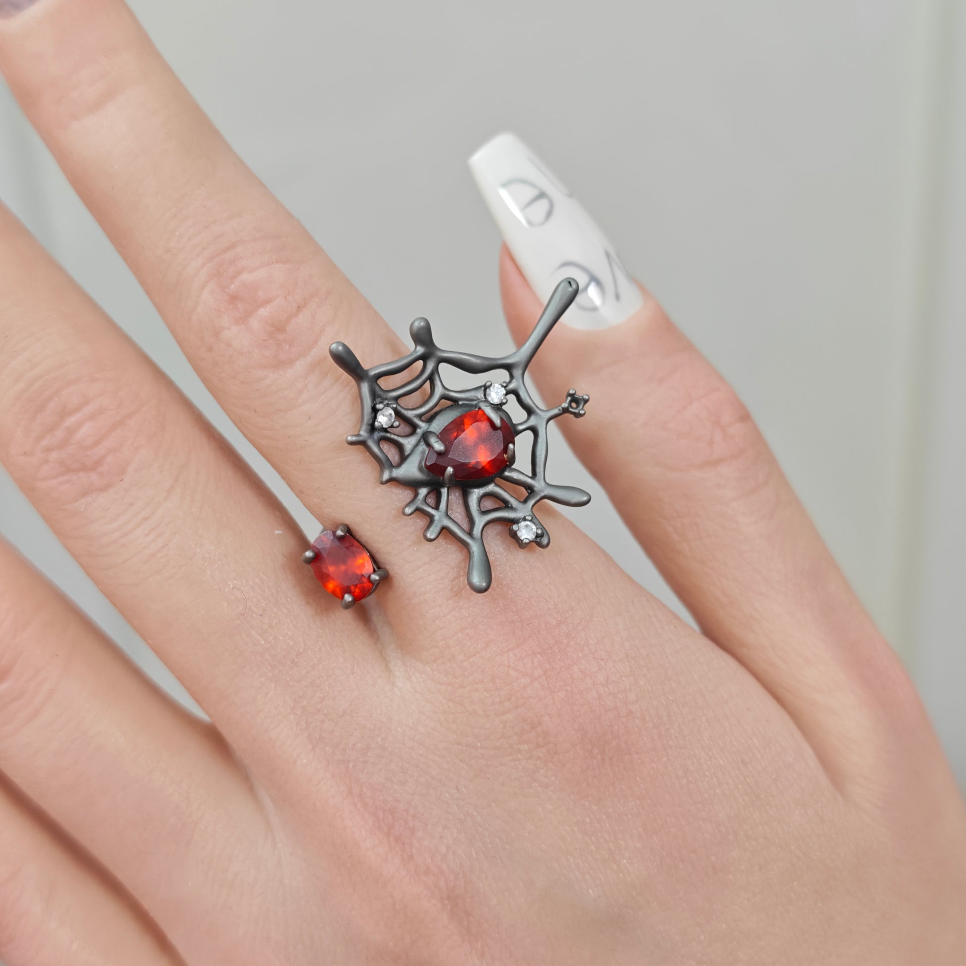 Spider Web Ring on black mannequin hand, front view close-up