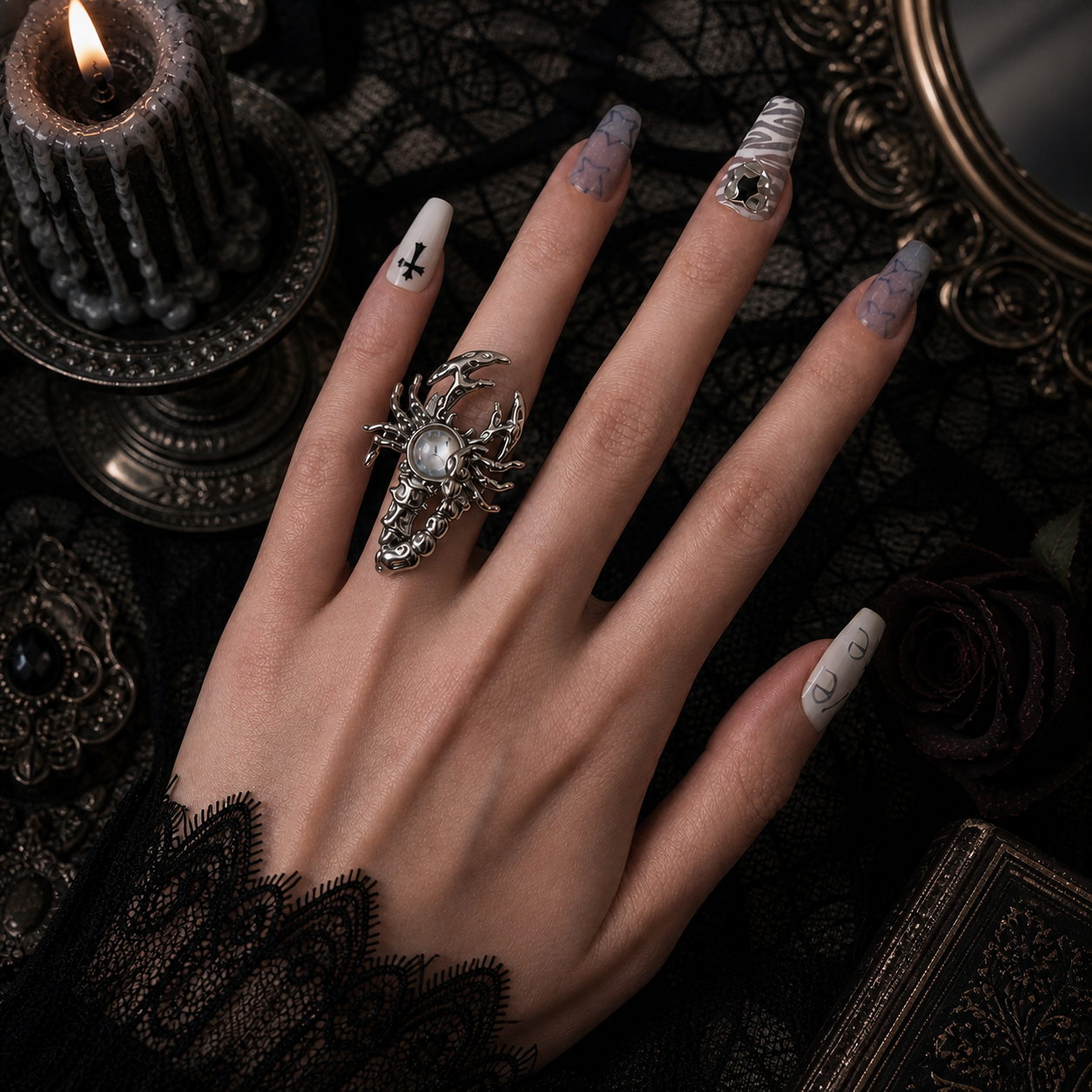 Silver sculptural scorpion ring with iridescent aurora stone worn on finger, dark gothic candle background
